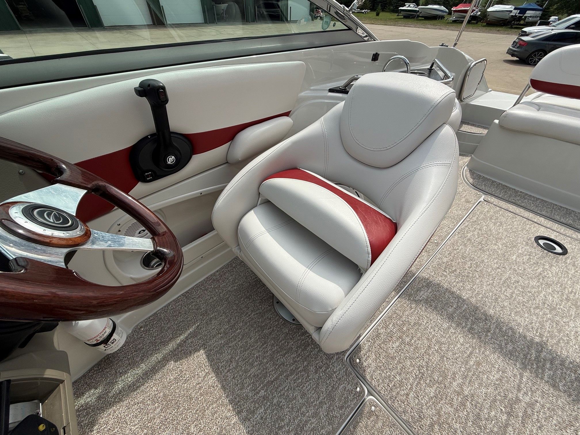 Interior of a 2012 Crownline 252 EX boat with beige carpet and white seats.