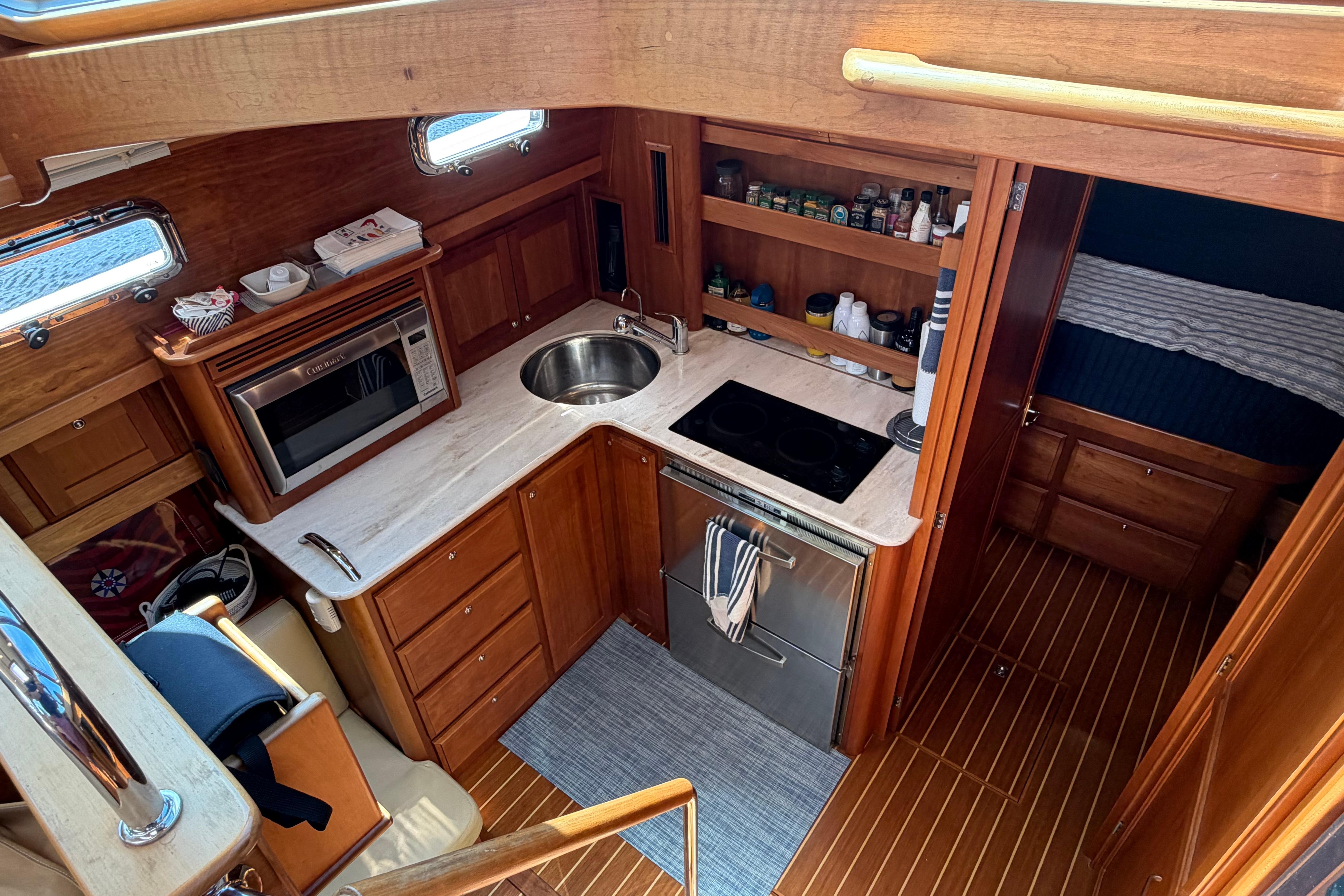 2015 Sabre 38 Salon Express yacht interior kitchen with wood cabinetry and modern appliances.