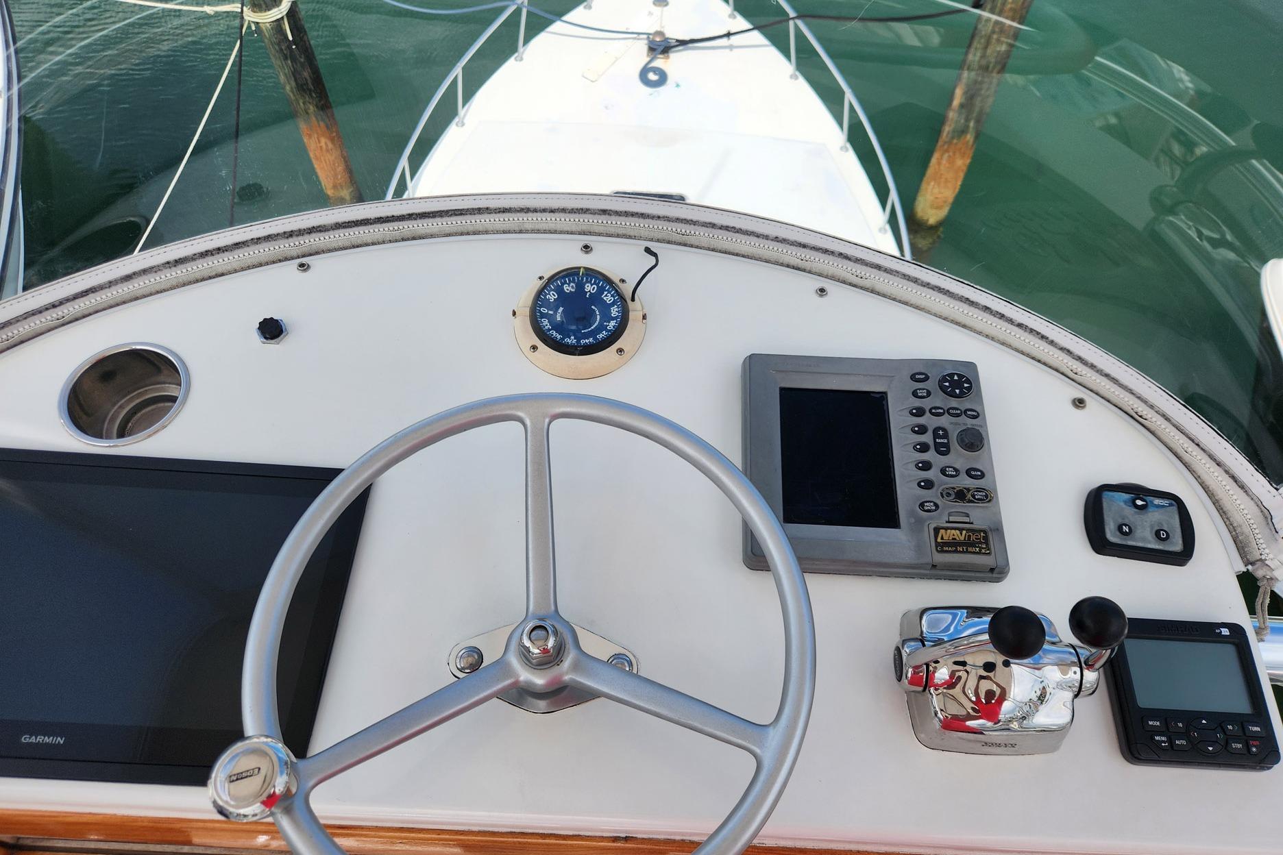 1987 Young Brothers Custom Sport Fish helm with navigation instruments and steering wheel.