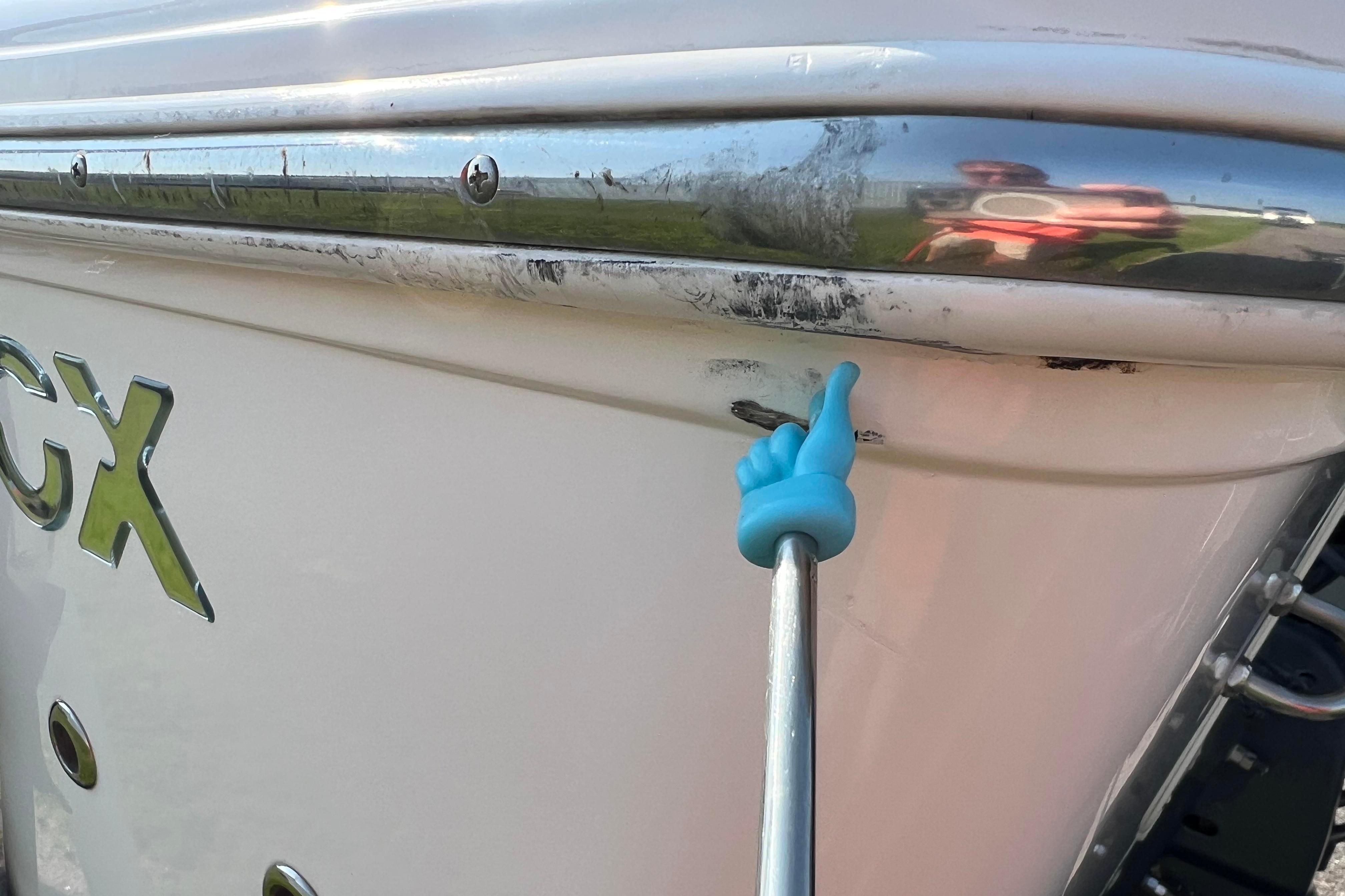 2012 Sea Fox 206 Center Console boat with visible hull damage and reflection.