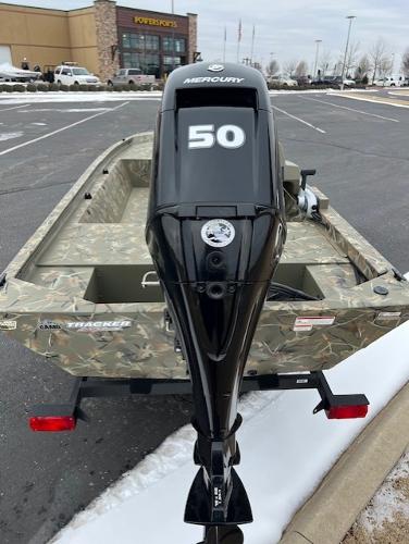 2025 Tracker Grizzly 1648 SC boat with Mercury 50 outboard motor in parking lot.