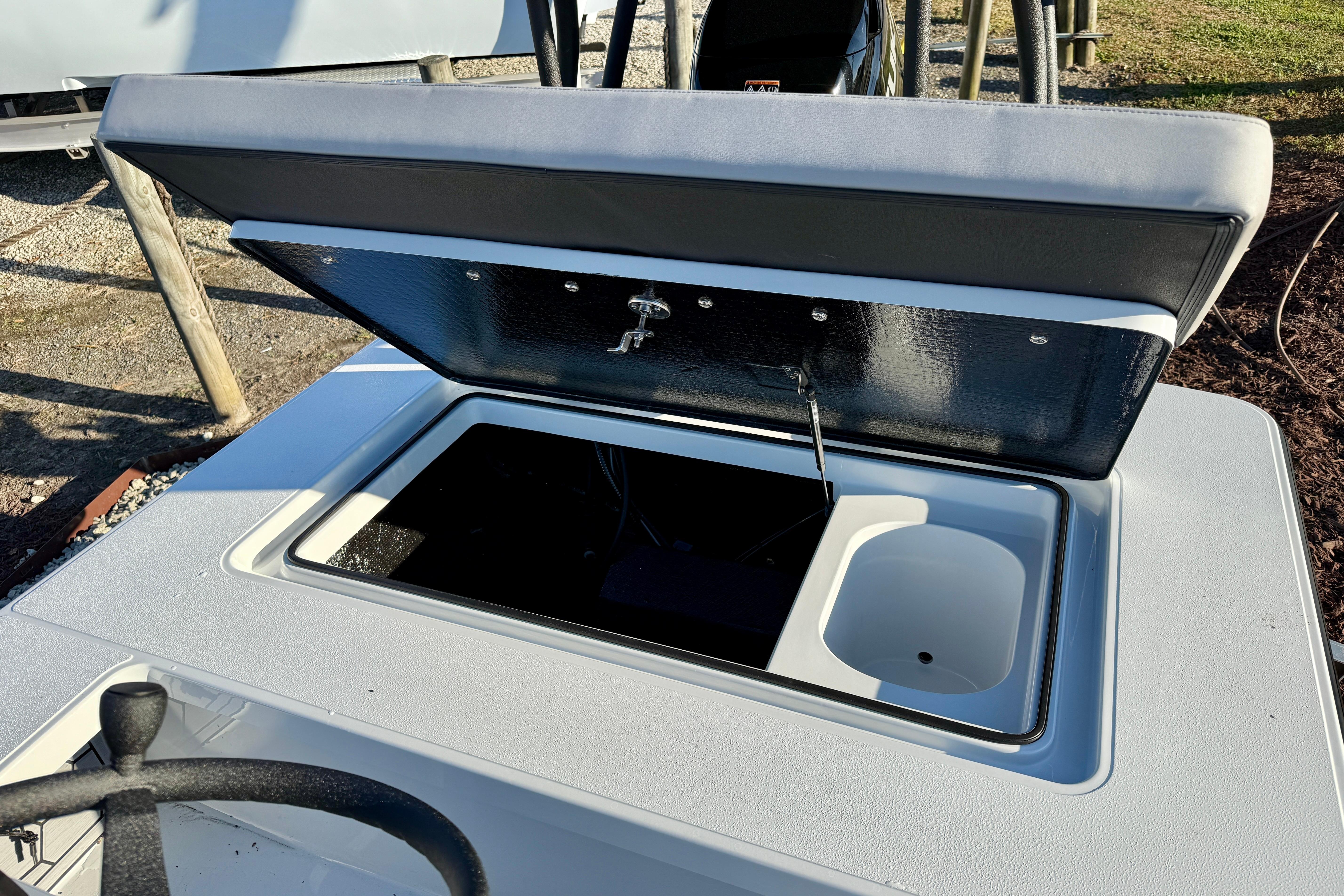 2026 East Cape EVO 17V boat with open storage compartment and steering wheel.