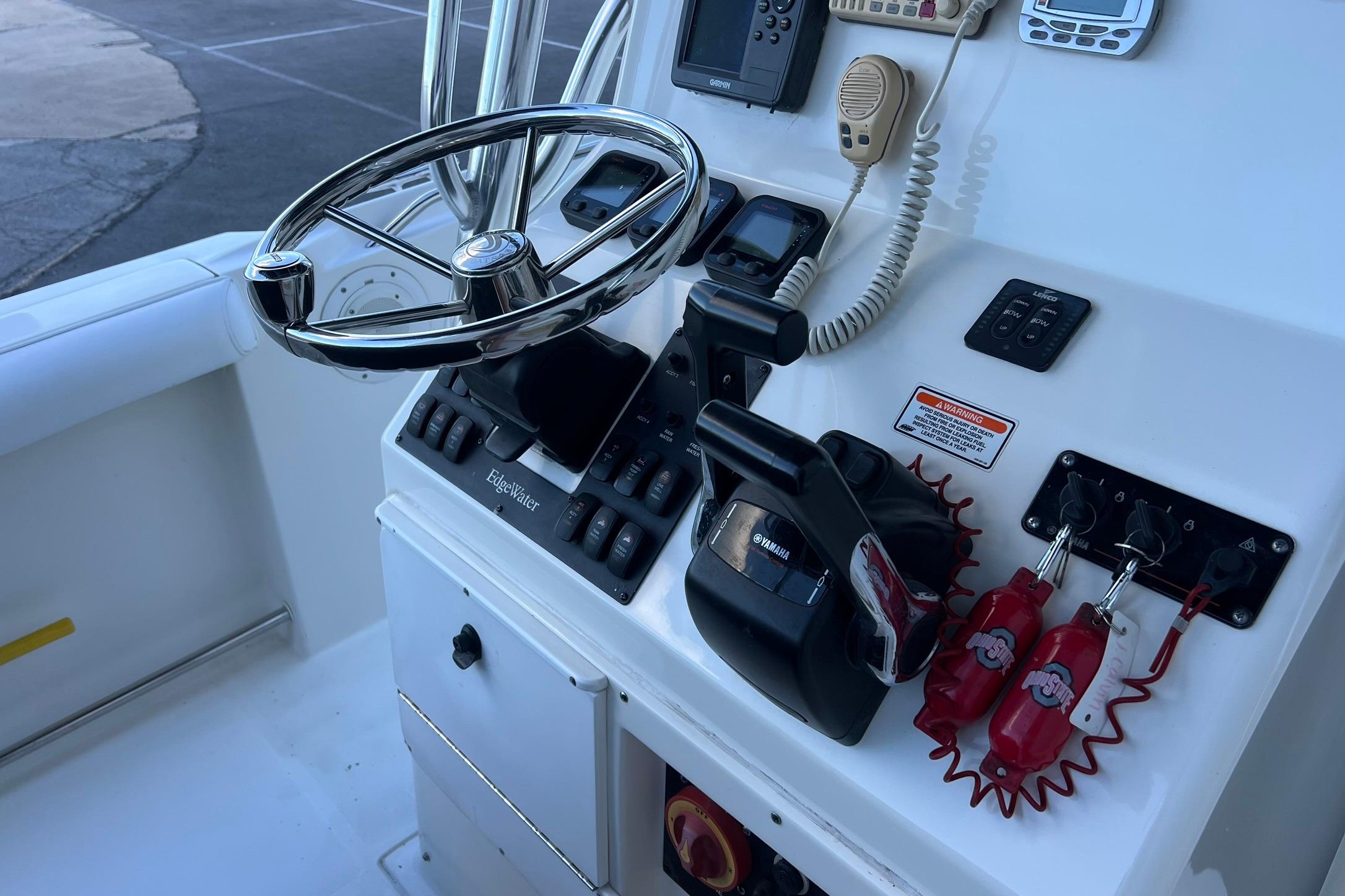 Edgewater 245CC 2006 boat console with steering wheel and controls.