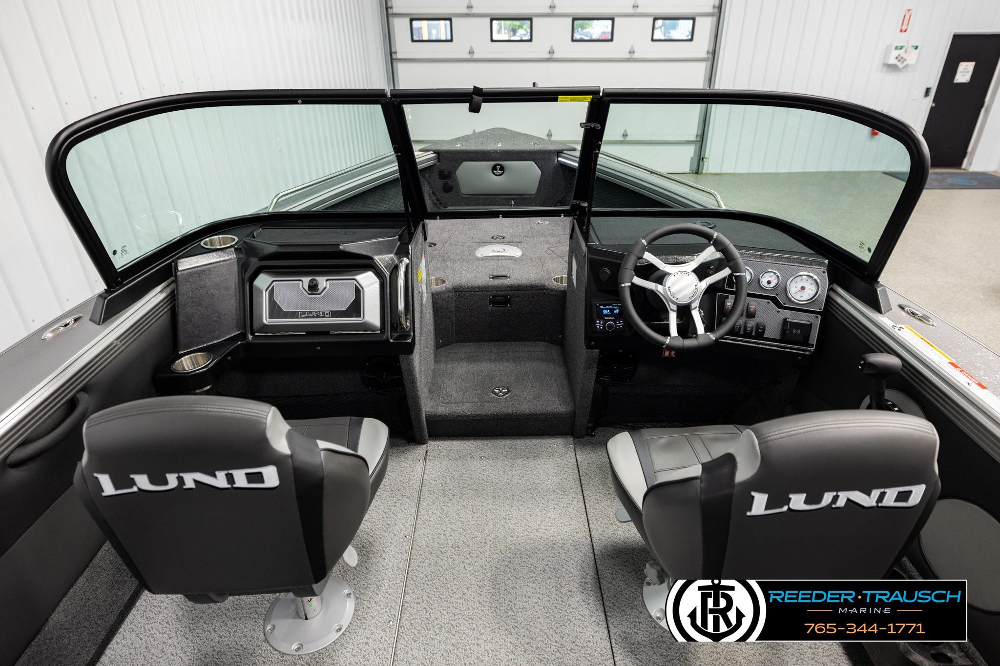 Interior of 2026 Lund 1975 Tyee boat with steering console and seating.
