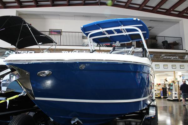 2025 Cobalt R6 boat with blue hull and canopy displayed indoors.
