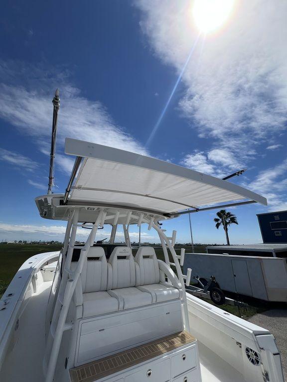 2021 Regulator 41 boat with sunshade under blue sky.
