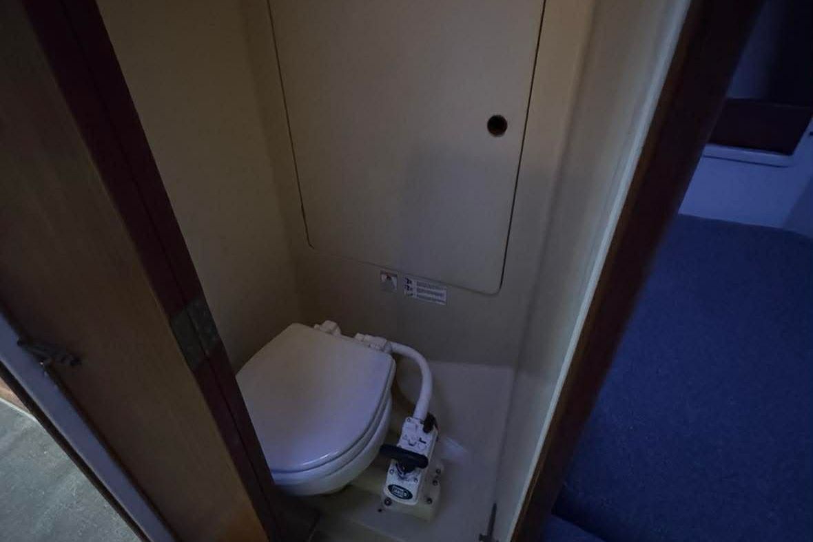 A small bathroom with a toilet and a closed door.