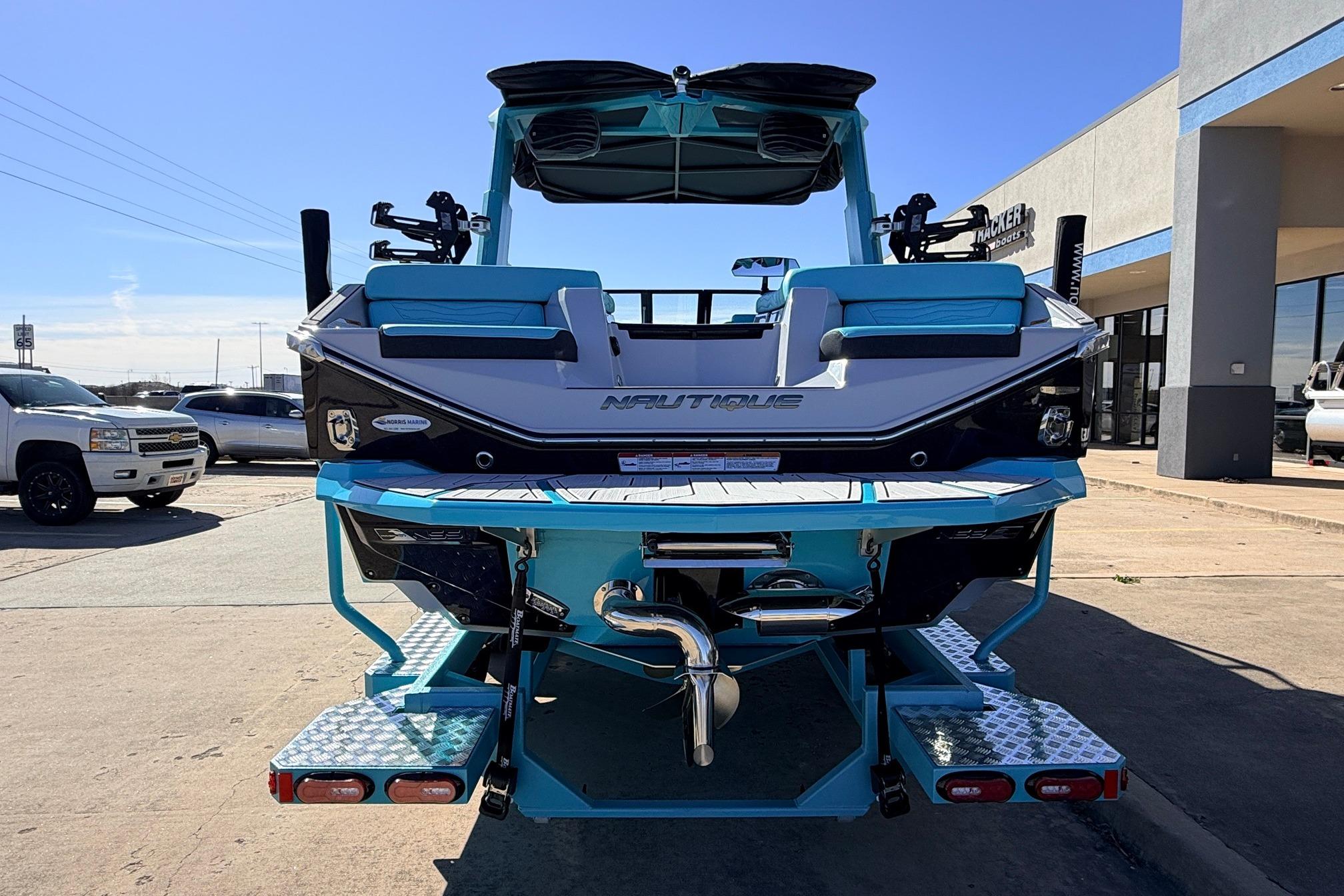 2026 Nautique Super Air Nautique G23 boat, rear view, vibrant blue and white design.