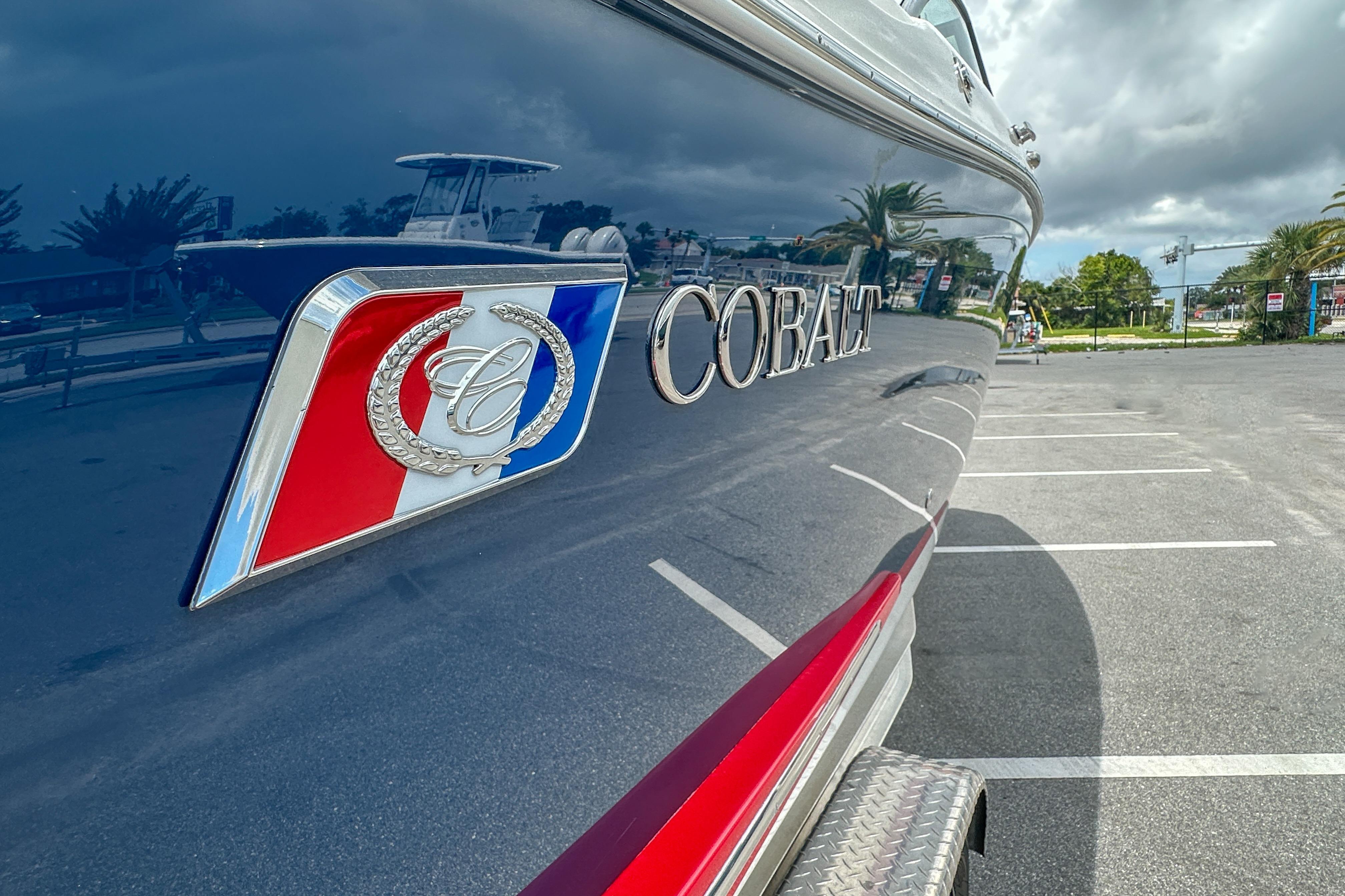 2022 Cobalt 25SC boat with logo, parked in a sunny lot.