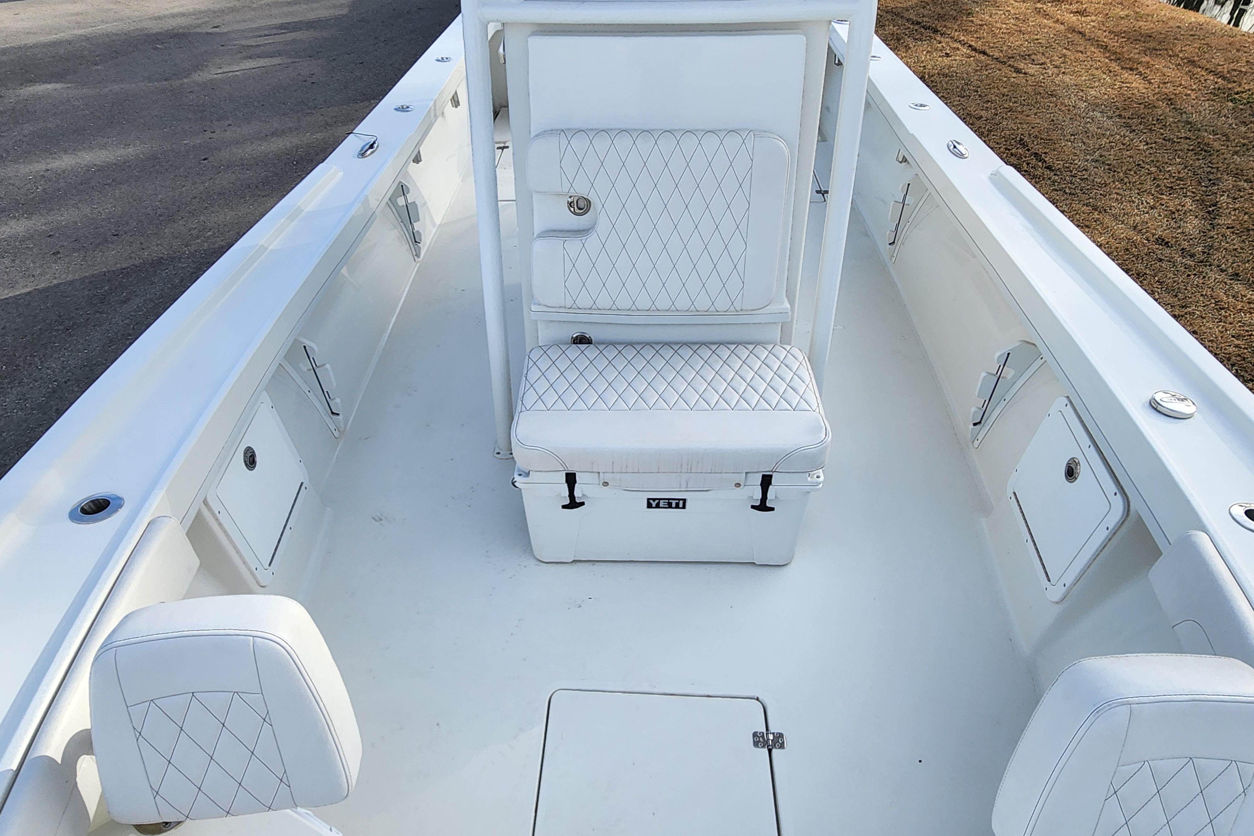 2024 Pair Customs 27 CC boat interior with white seating and storage compartments.
