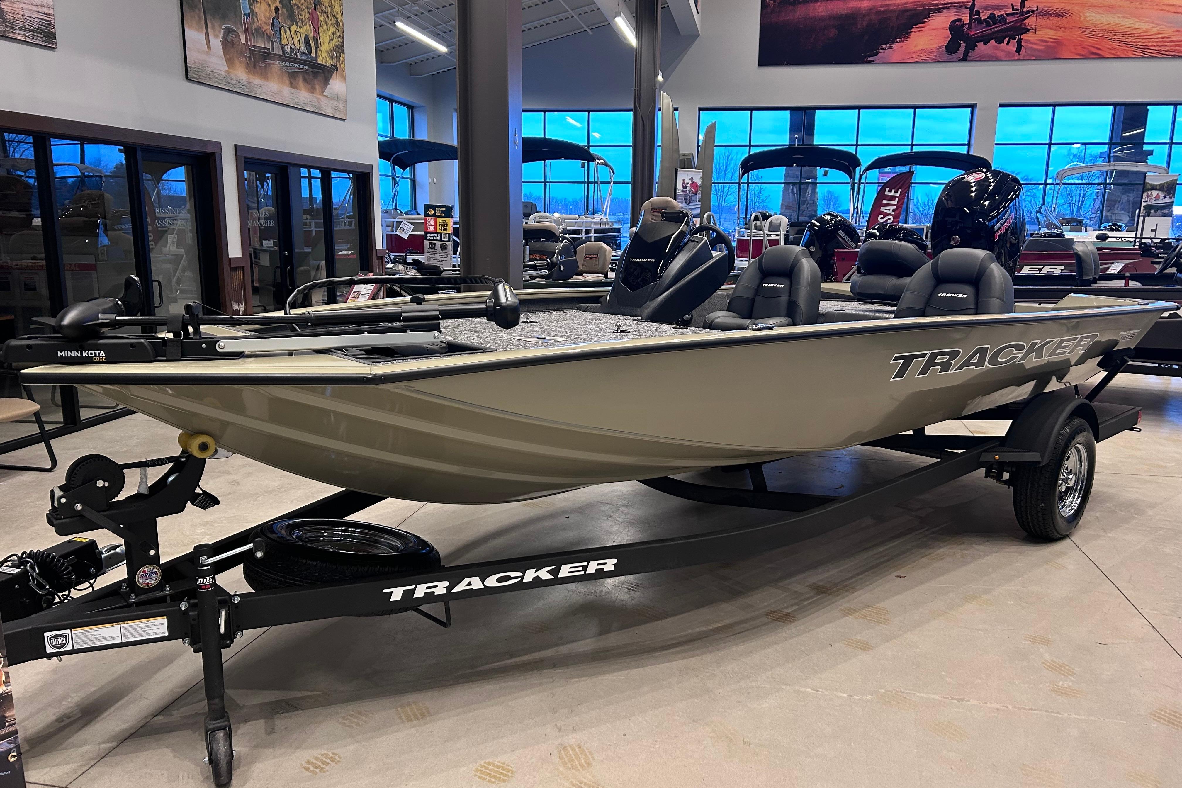 2026 Tracker Pro Team 195 boat displayed in showroom, featuring sleek design and modern equipment.