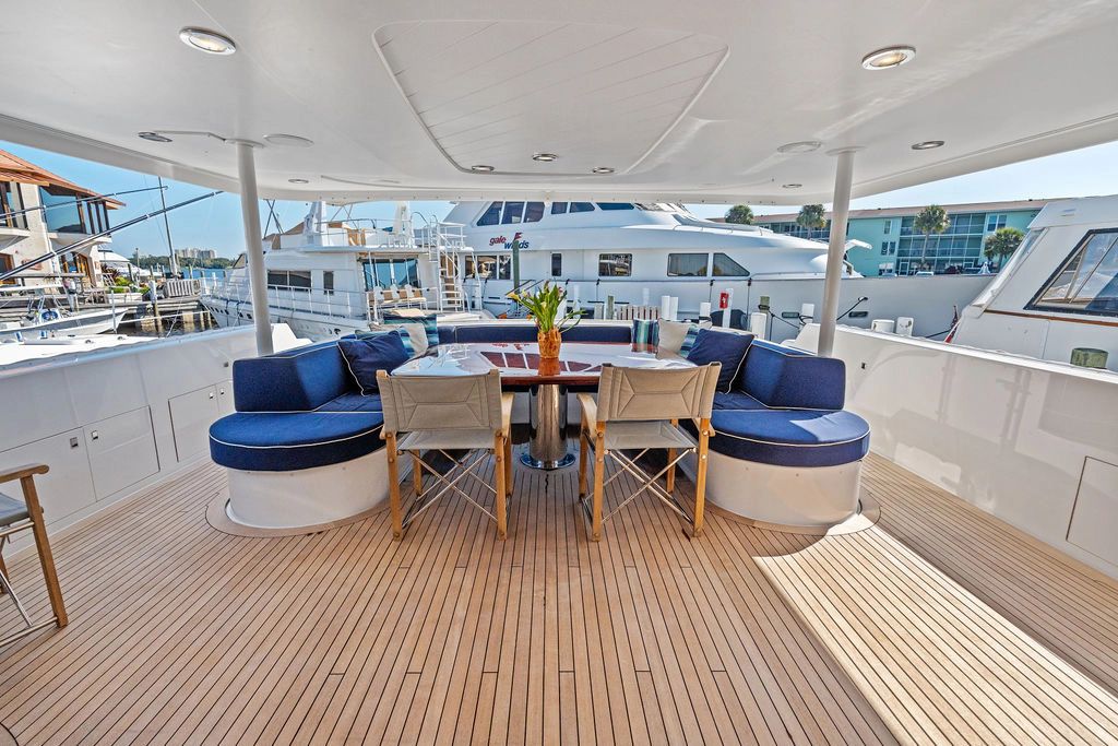 Luxurious deck of Westport 112 yacht, 1999 model, featuring blue seating.