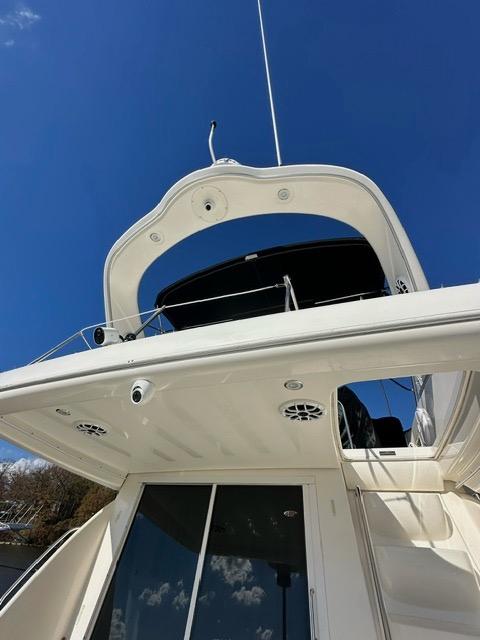 2003 Meridian 381 Sedan yacht against a clear blue sky.