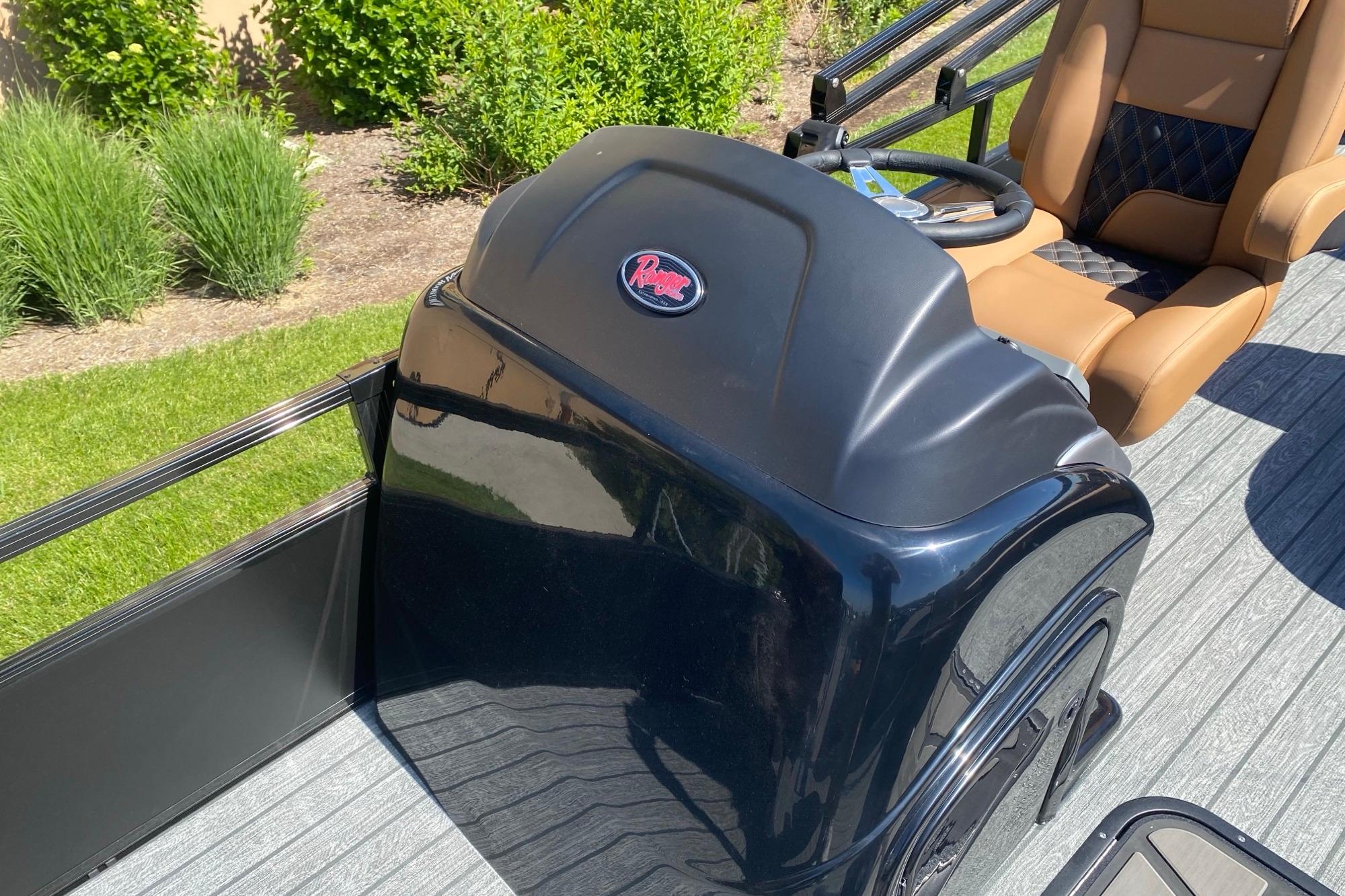 2026 Ranger 223F boat console with tan seating, outdoors in sunlight.