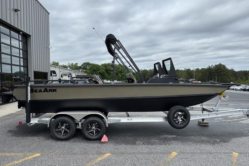 2026 SeaArk Predator 300 AK boat on trailer, parked outdoors near a building.