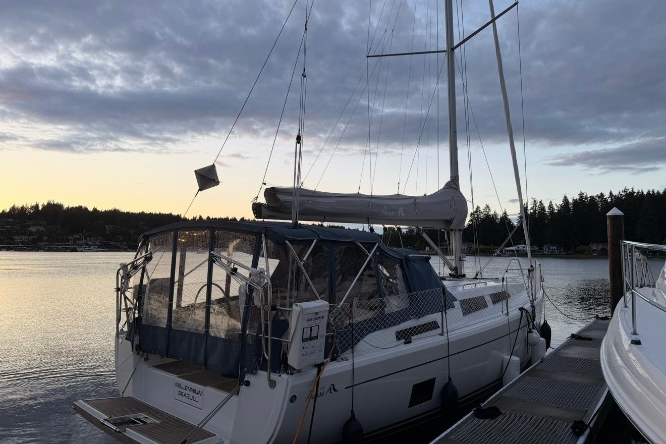 2022 Hanse 418 sailboat docked at sunset, with scenic waterfront view.
