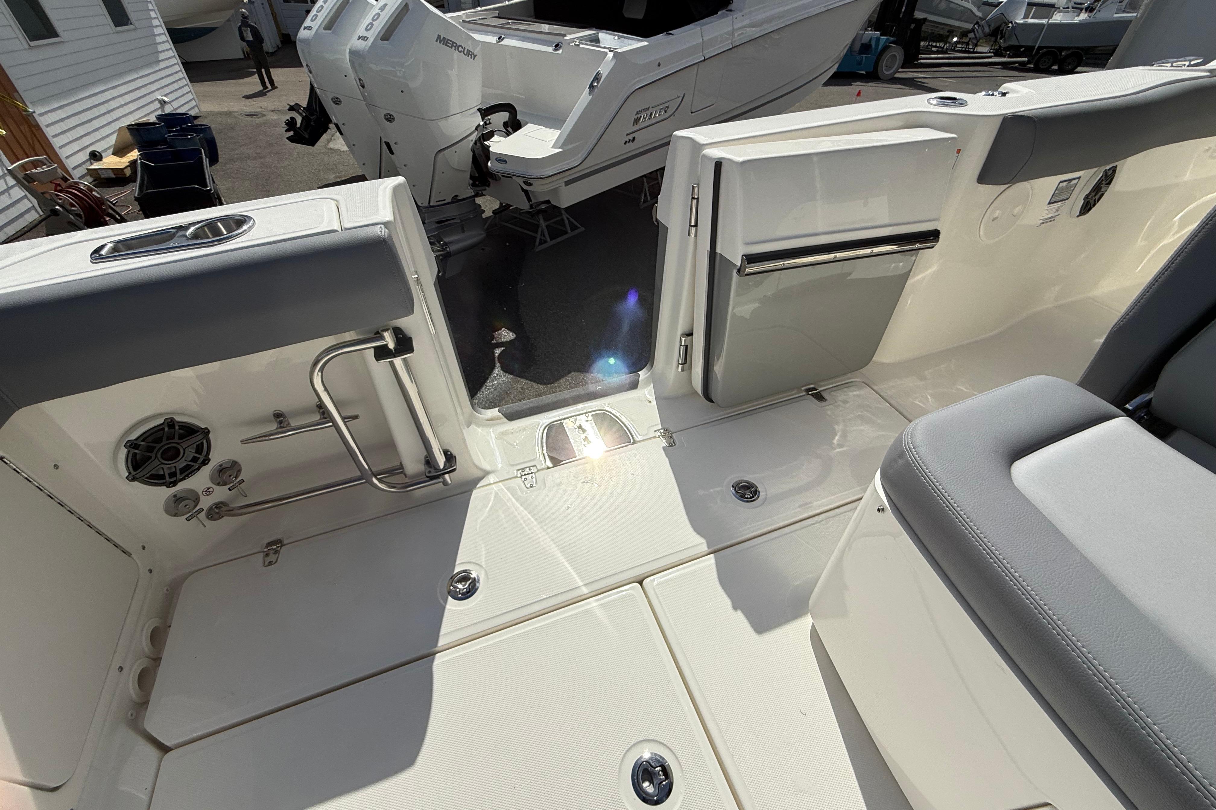 2026 Boston Whaler 330 Outrage boat interior with seating and storage compartments.