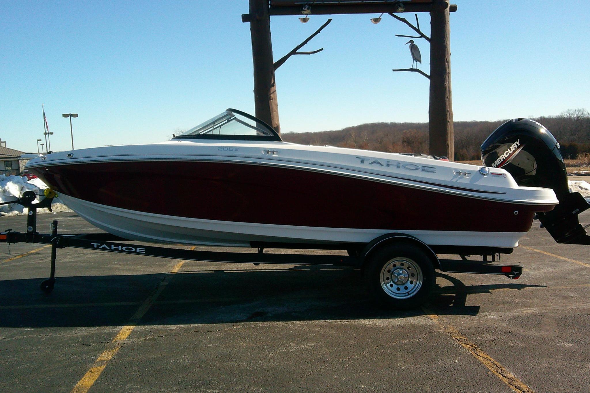 2024 Tahoe 200 S boat on trailer, parked outdoors, side view.