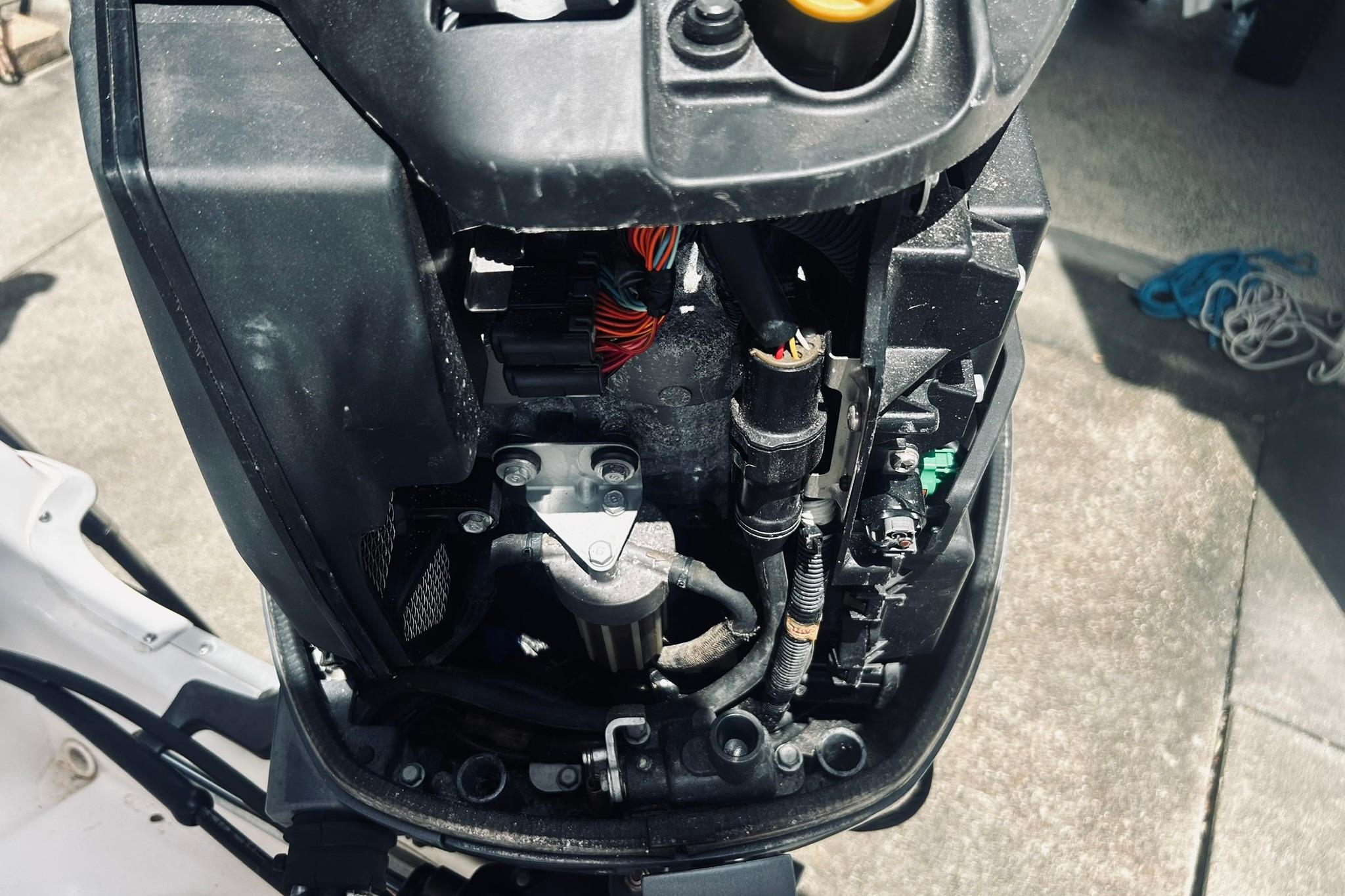 2013 Hurricane SunDeck Sport 201 OB engine compartment, showcasing internal components and wiring.