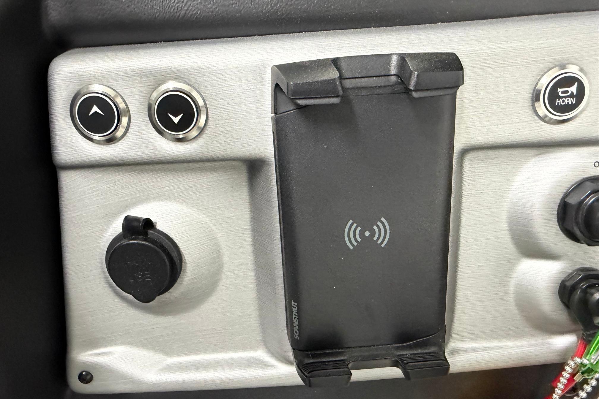 Control panel of 2026 South Bay 525SB2 with wireless charging dock and buttons.