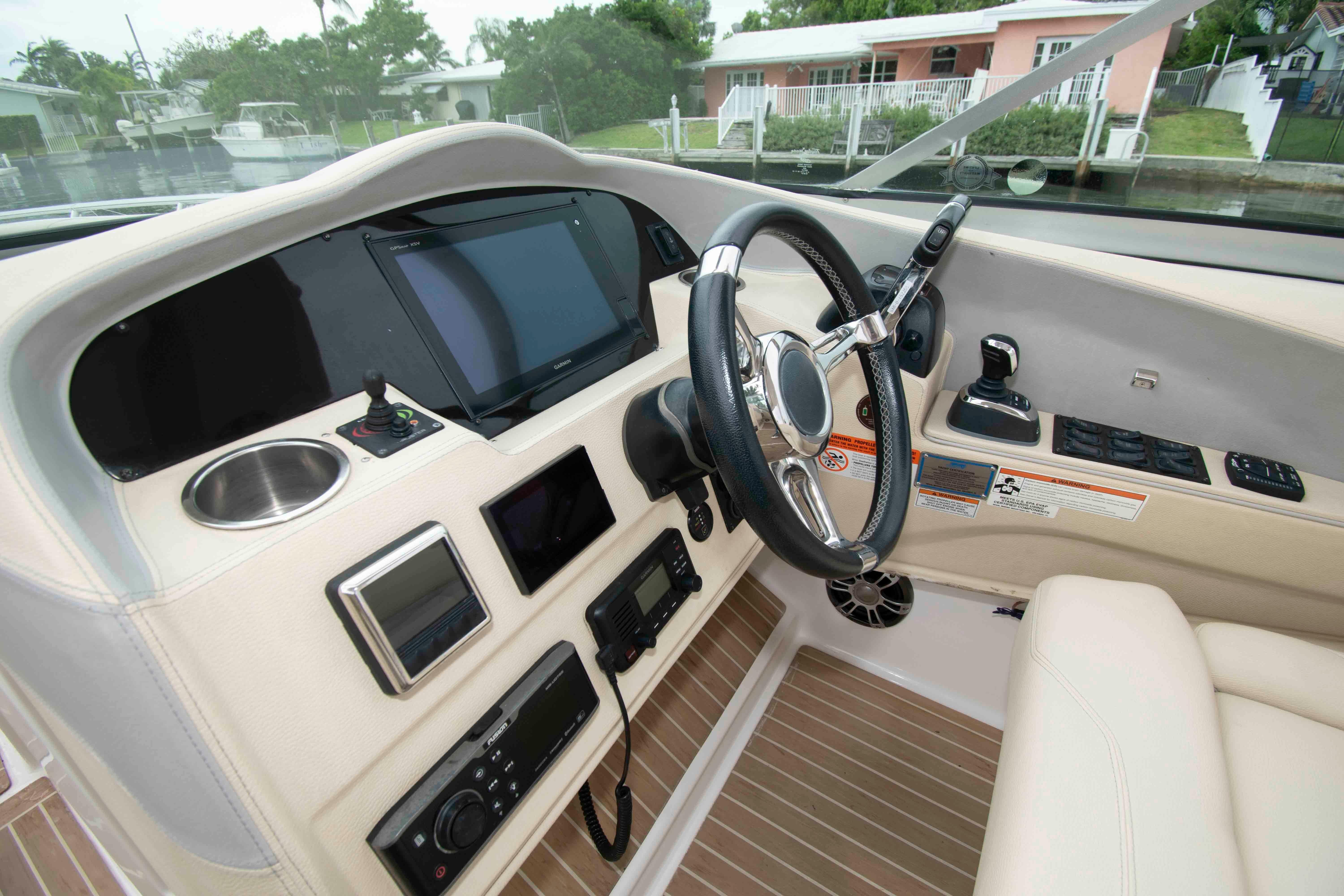 2019 Regal 33 OBX boat cockpit with steering wheel and navigation controls.