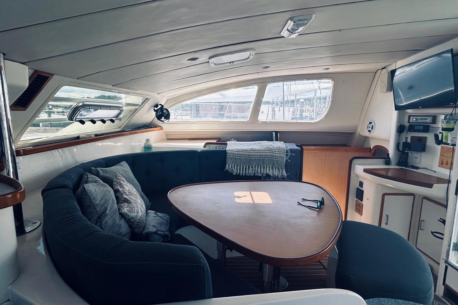 Interior of 2001 Robertson & Caine Leopard yacht with cozy seating and modern amenities.