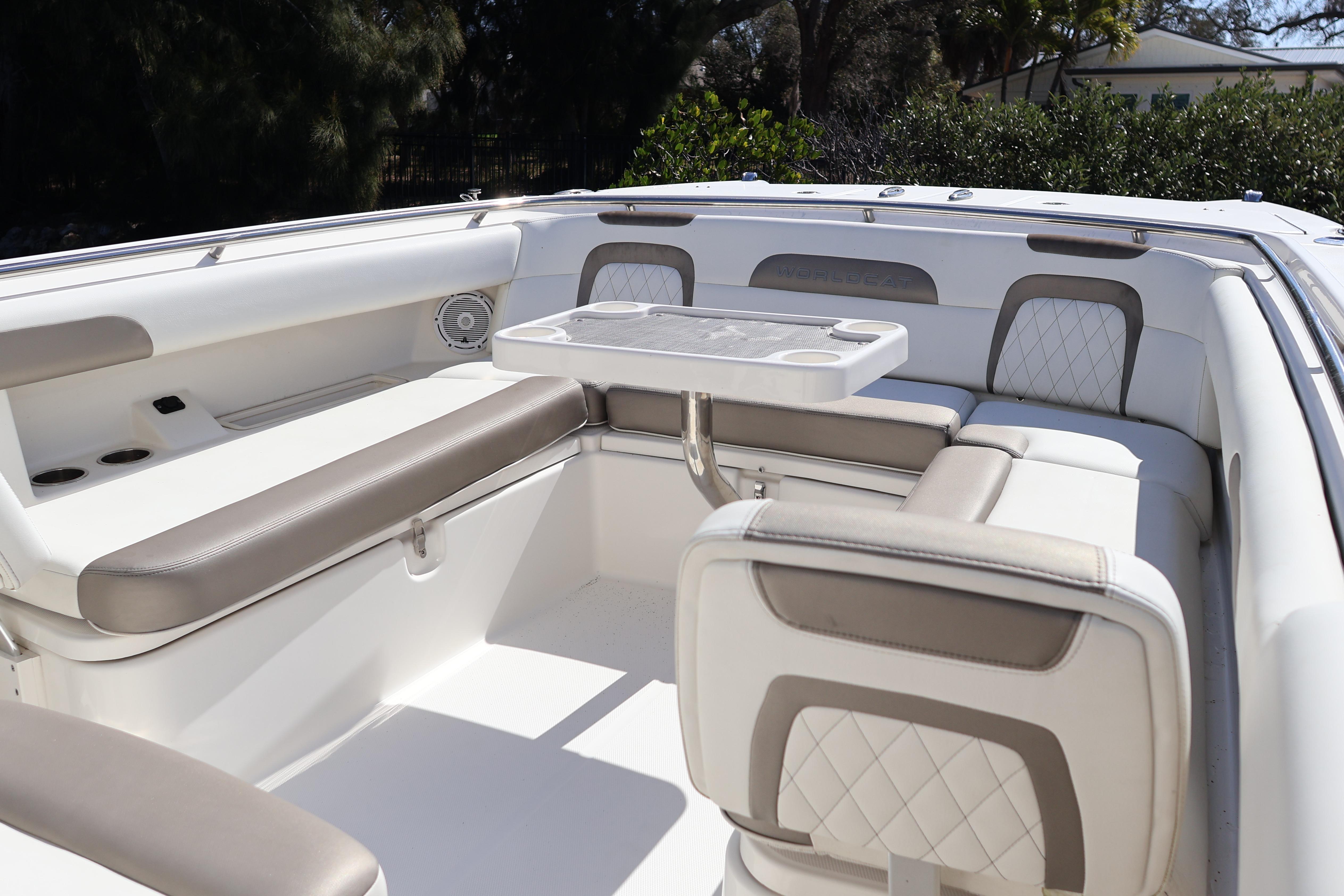 2022 World Cat 280 CC-X boat interior with cushioned seating and table.