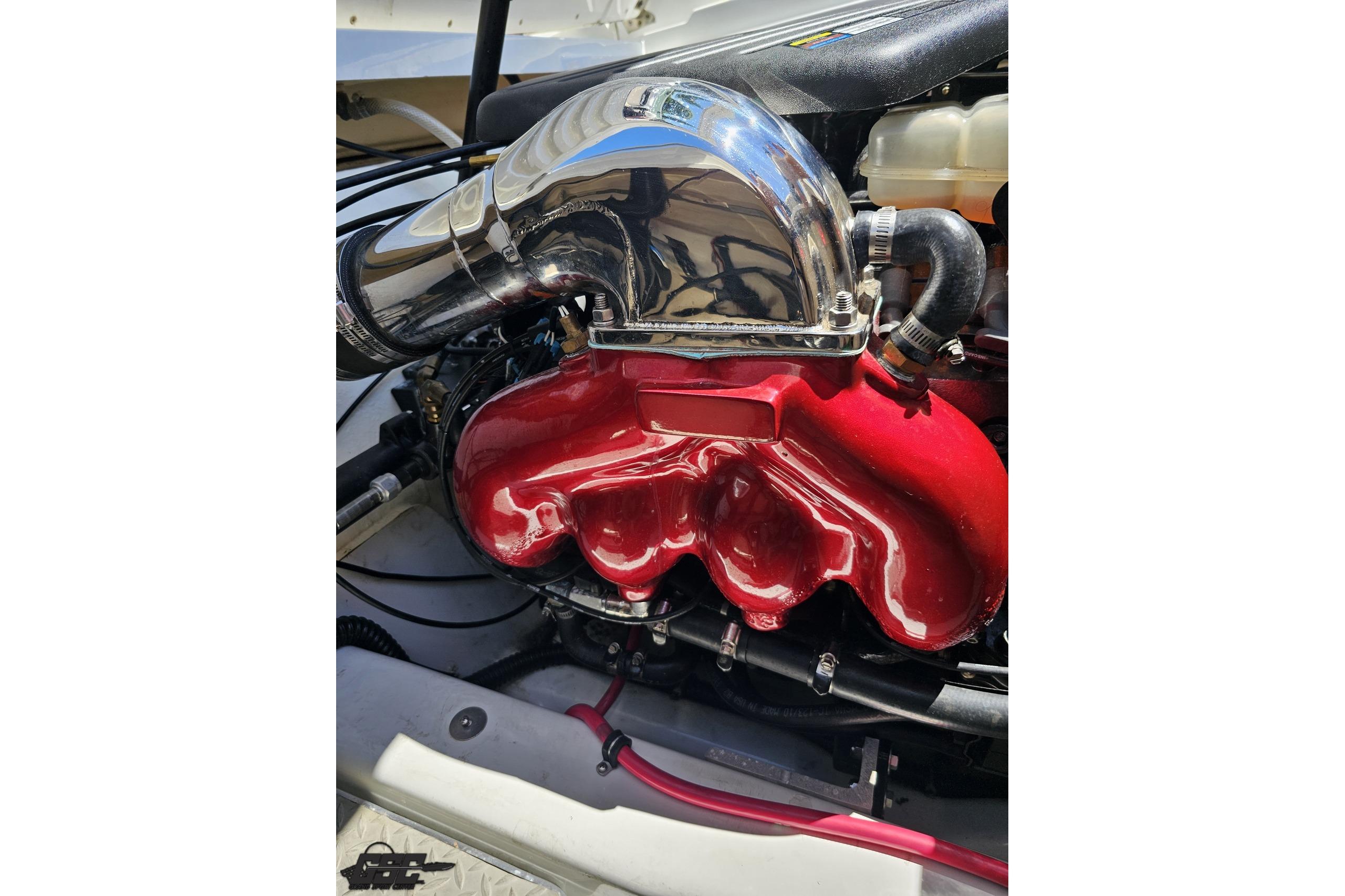 Engine of a 2005 Formula 271 FASTech boat with red intake manifold.