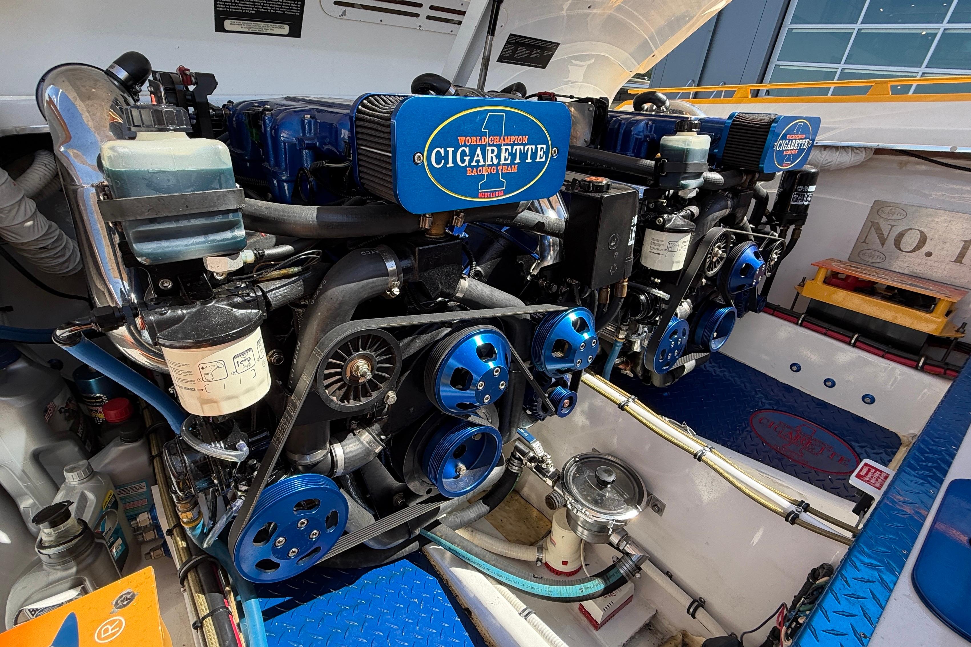 Engine compartment of a 2002 Cigarette 35' Cafe Racer boat, showcasing dual engines.