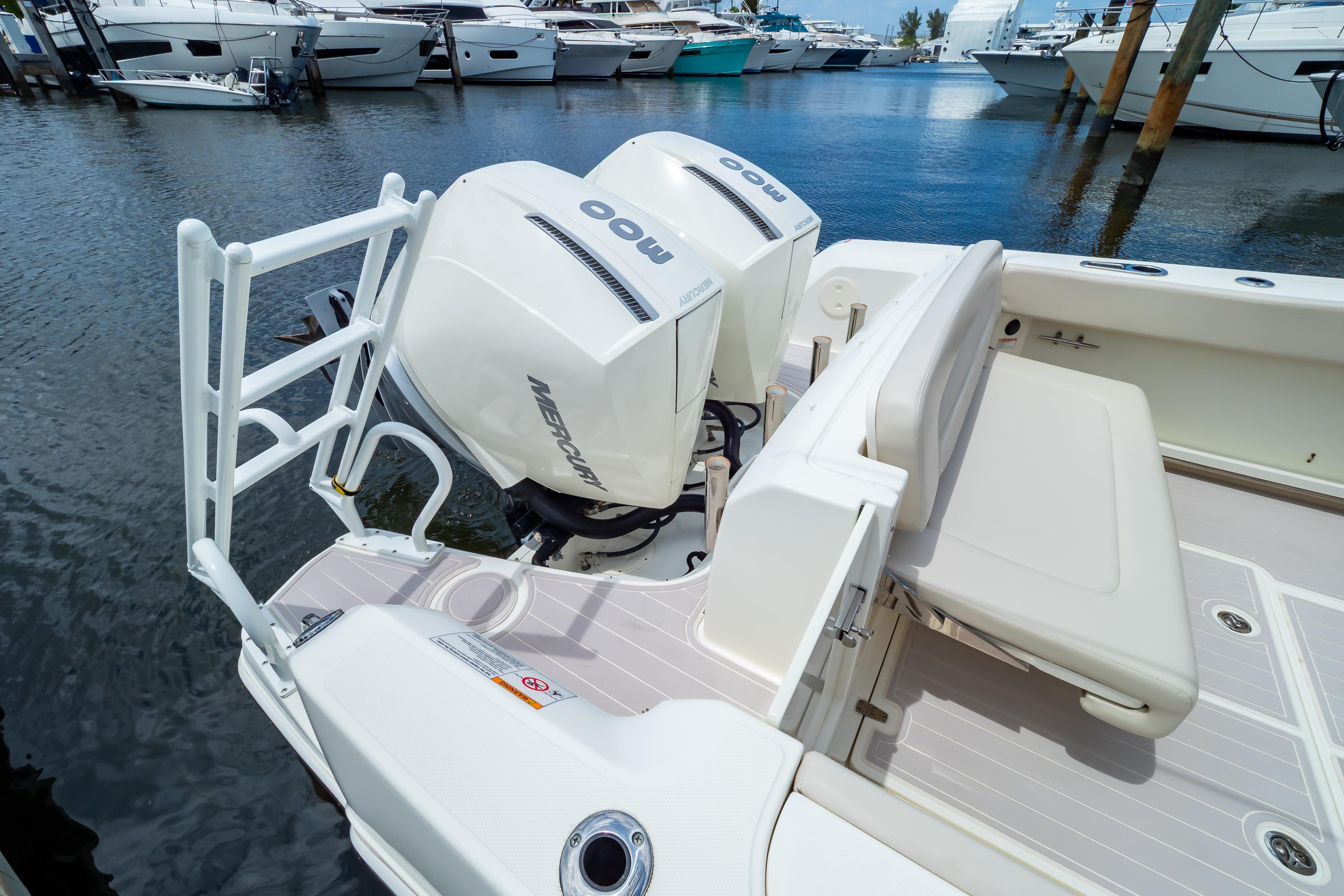 2019 Boston Whaler 270 Vantage boat with dual Mercury engines docked at marina.