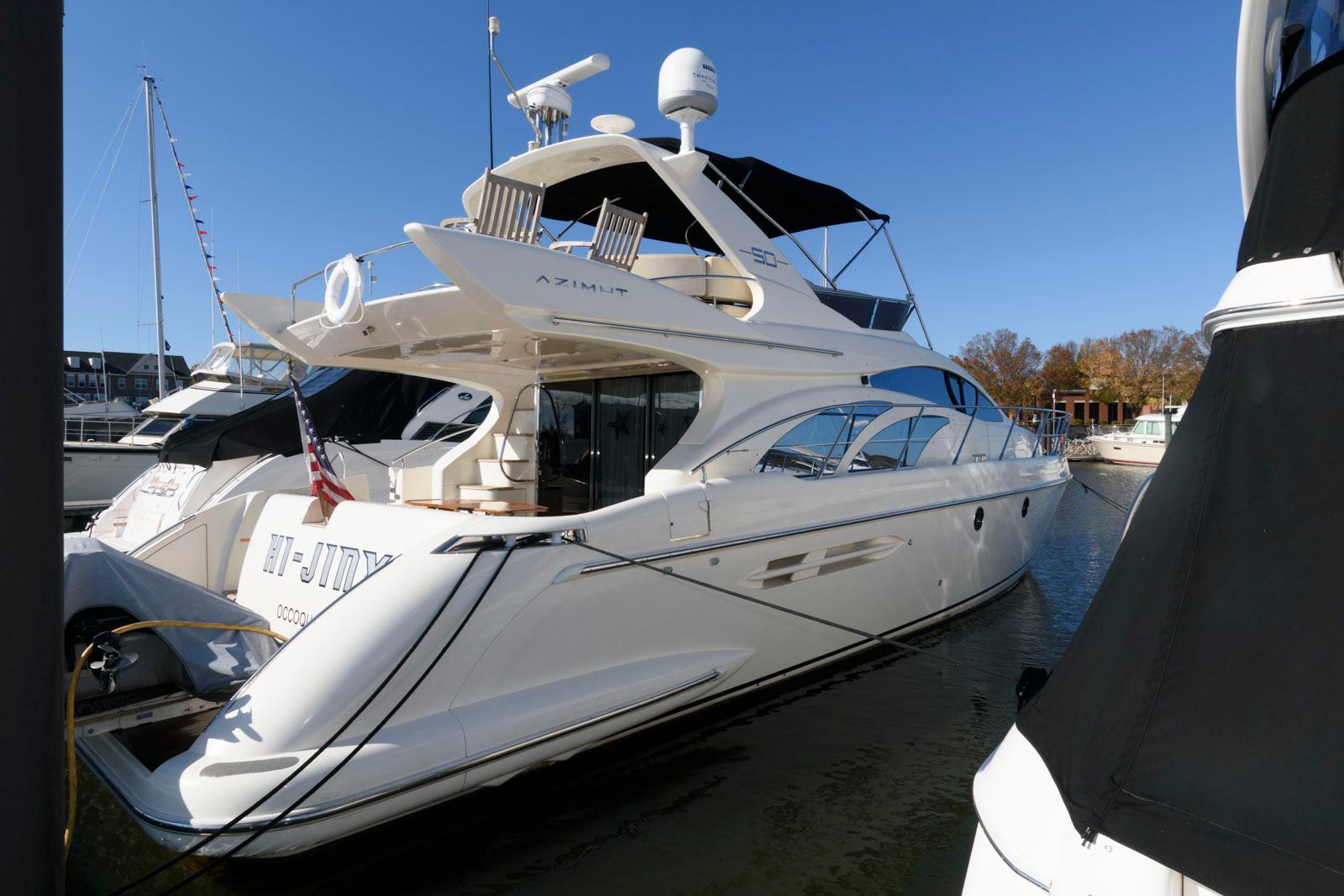 Azimut 50 Flybridge 2005 yacht docked in marina, sleek design, sunny day.