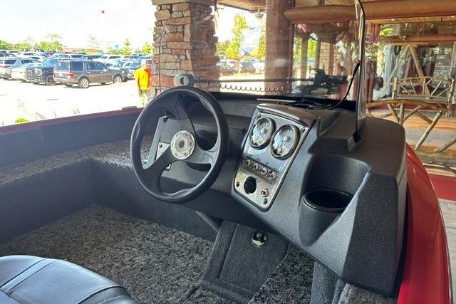2026 Tracker Pro Guide V-16 SC boat interior with steering wheel and dashboard controls.