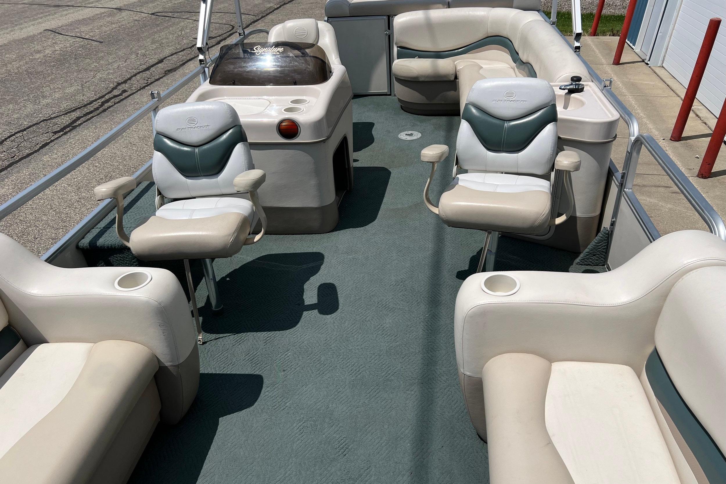 2006 Sun Tracker Party Barge 24 interior with seating and helm station.