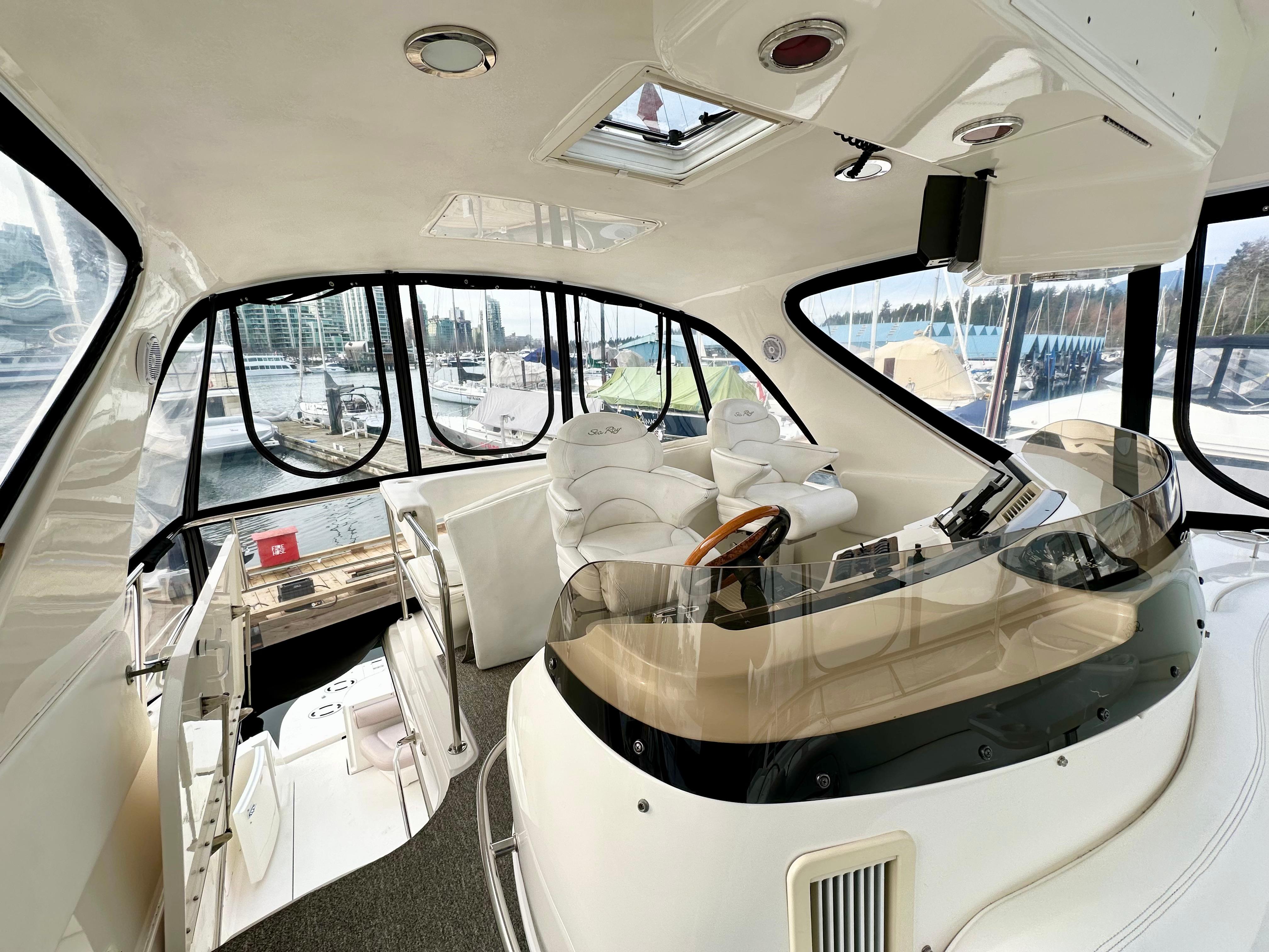 Interior of 2002 Sea Ray 560 Sedan Bridge yacht with modern helm and seating.