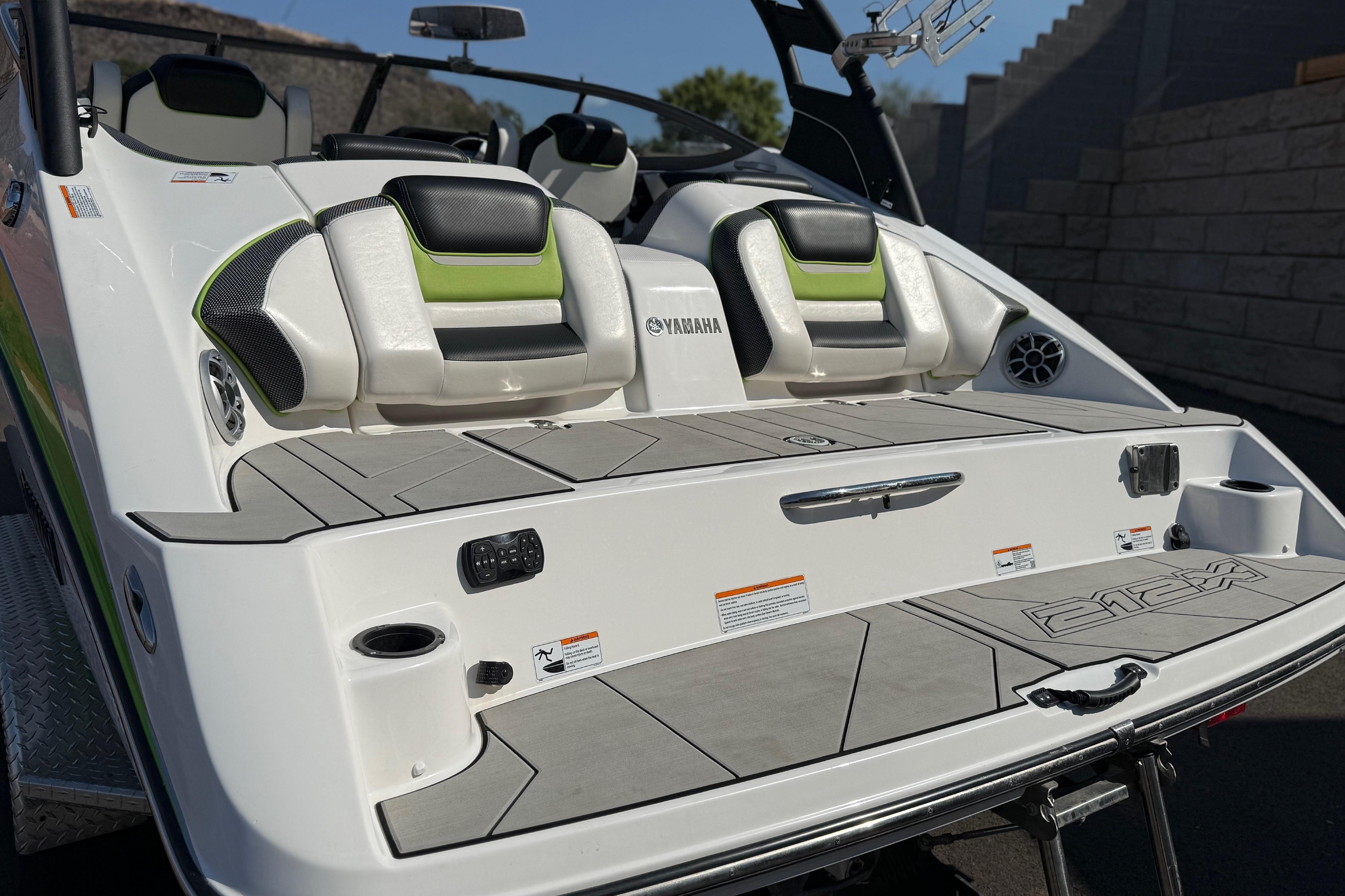 2022 Yamaha Boats 212XE rear deck with seating and speakers, showcasing modern design.