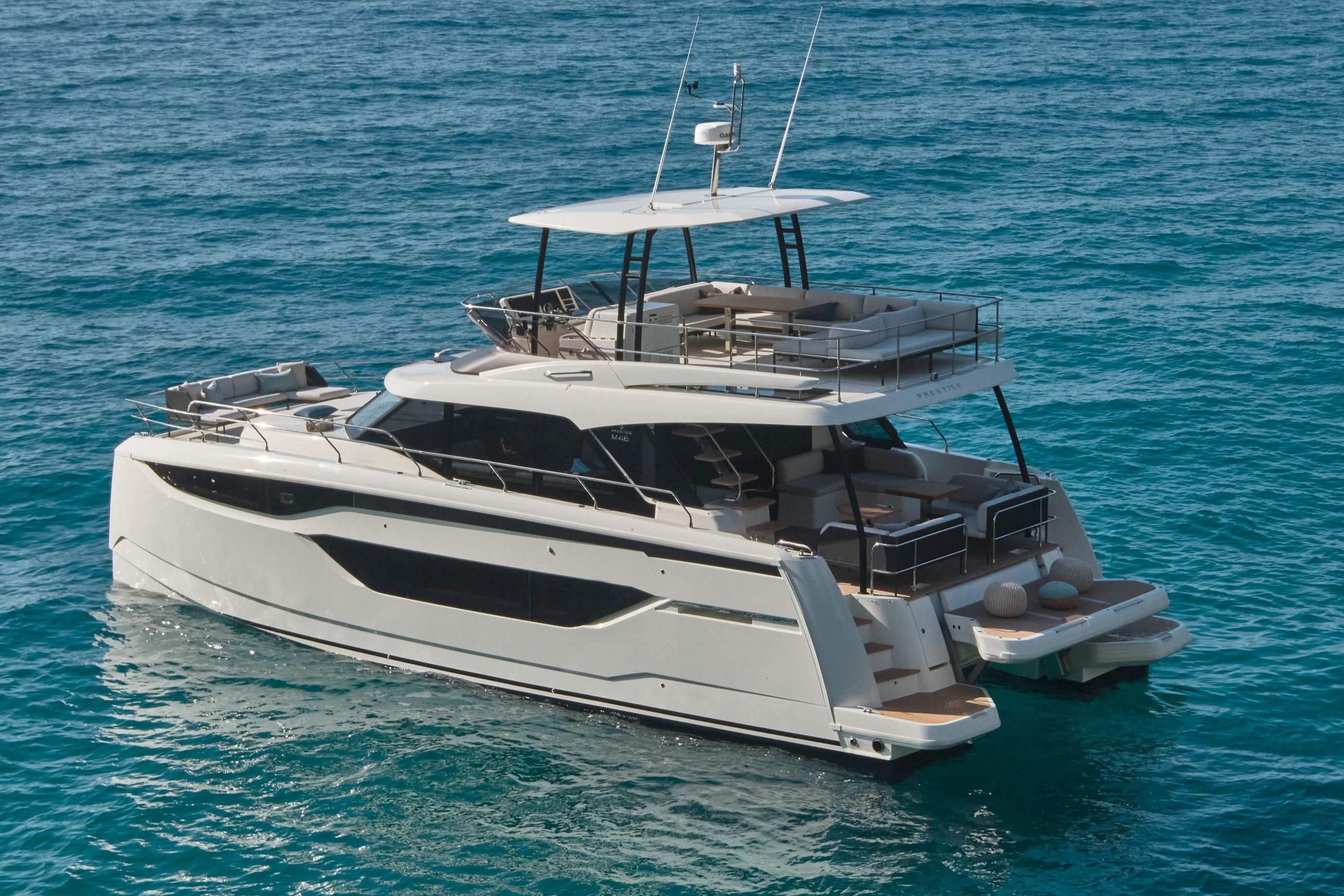 Luxurious 2026 Prestige M48 yacht cruising on clear blue ocean waters.