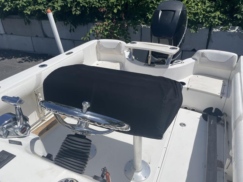 2006 Boston Whaler 210 Outrage boat interior with steering wheel and covered console.