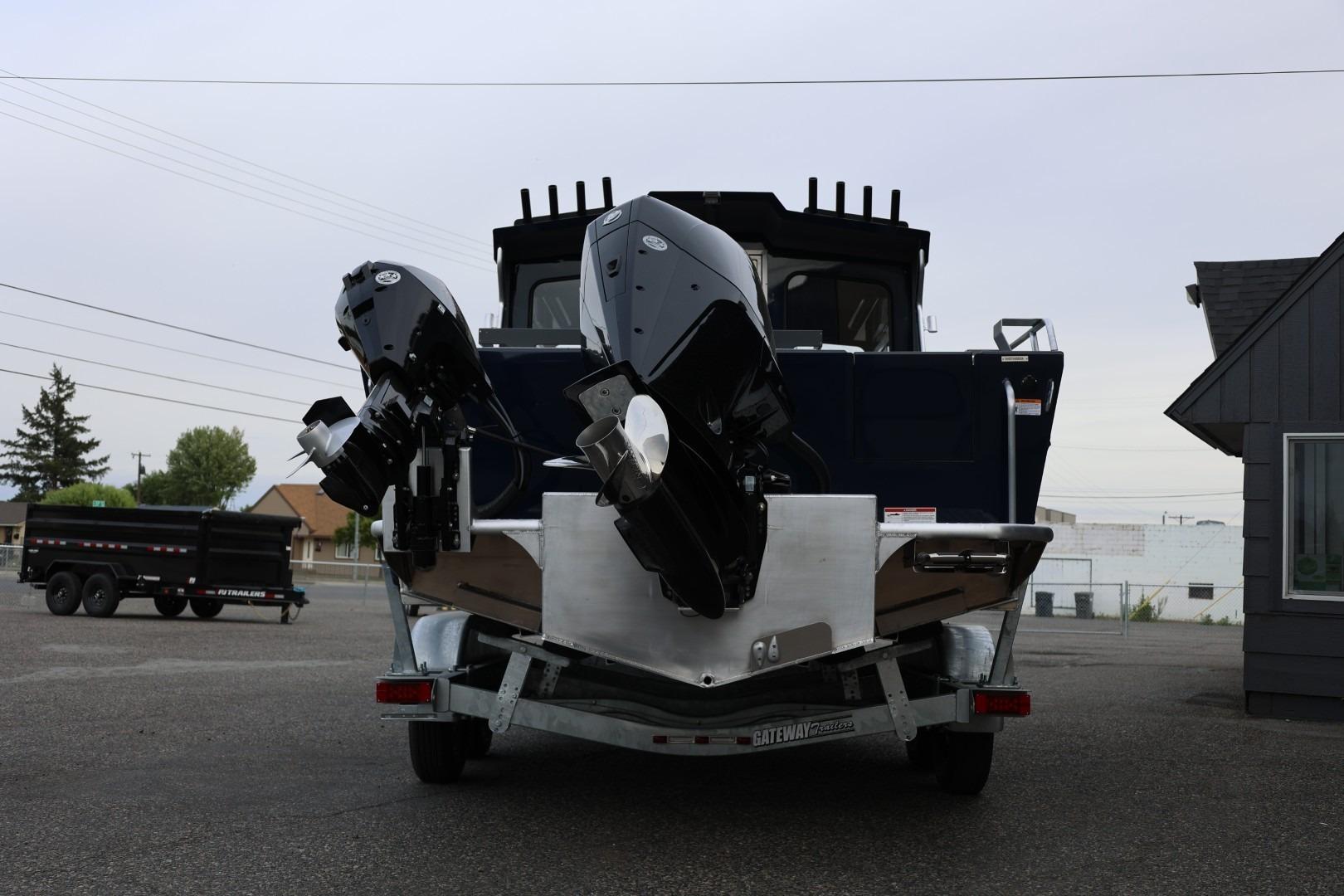 2026 Thunder Jet 24 Alexis Pro boat with dual outboard motors on a trailer.