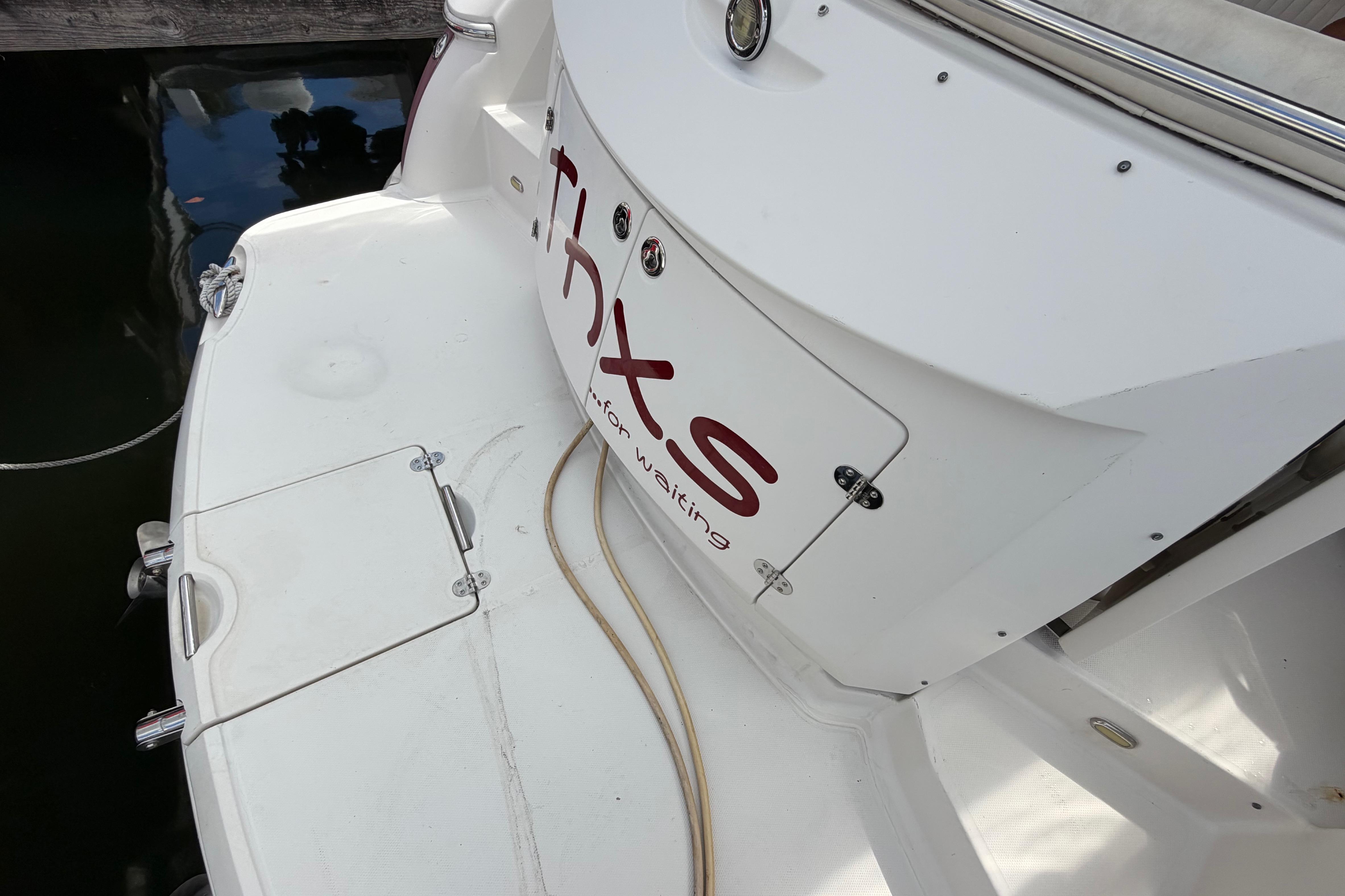 2007 Monterey 350 Sport Yacht stern view with docked platform and water reflection.