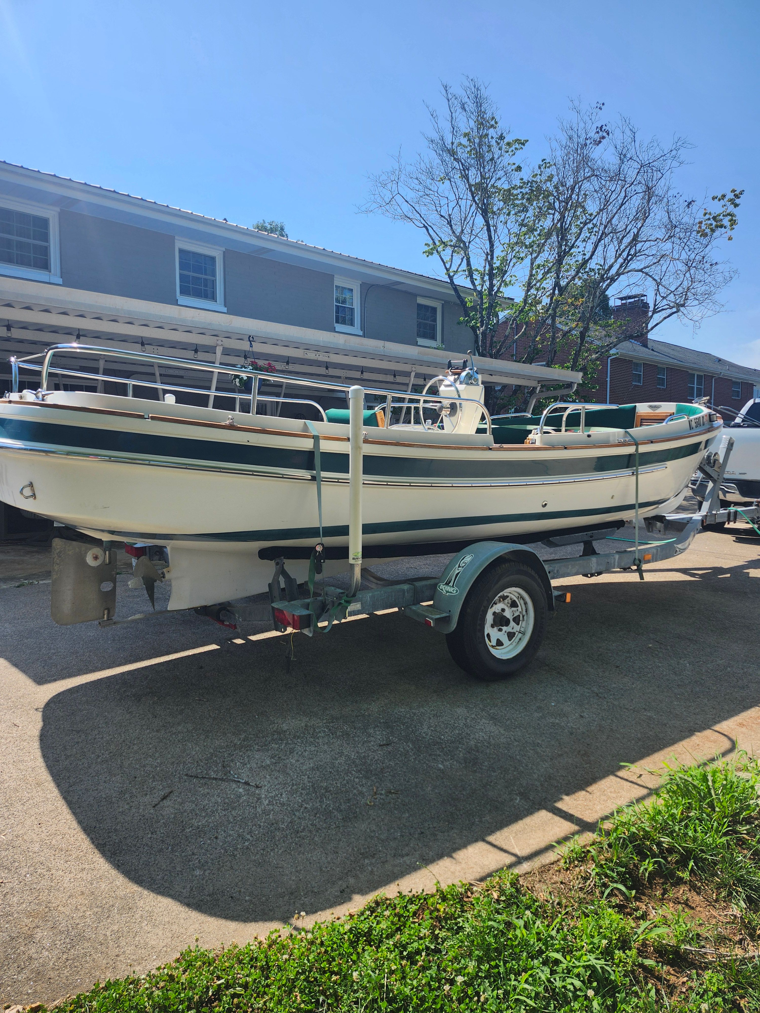 2000 Ranger Tugs Martini 21 Launch on a trailer in a driveway.