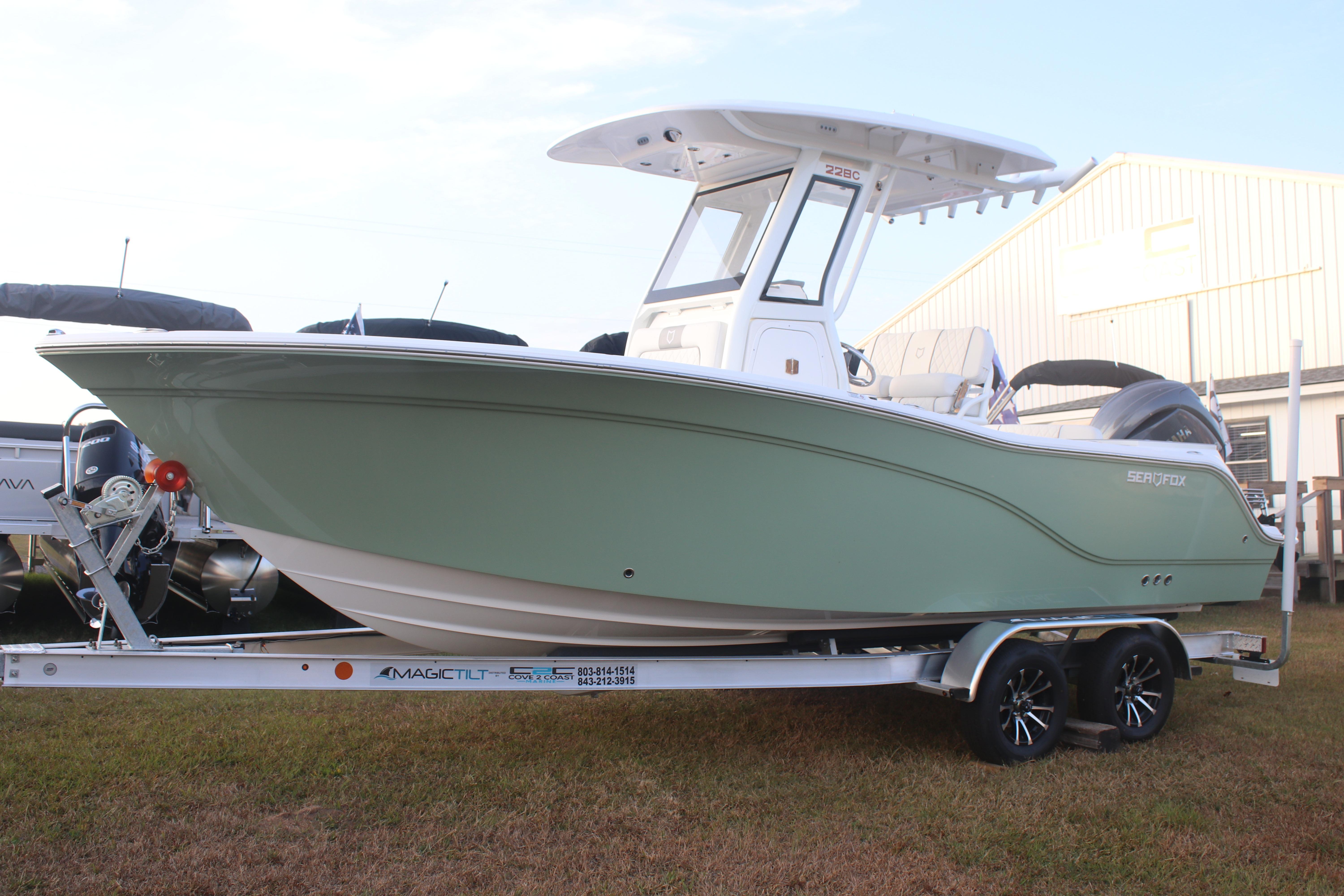 2026 Sea Fox 228 Commander boat on trailer, side view, outdoors.