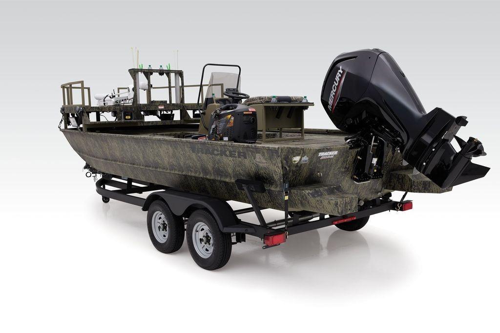 2026 Tracker GRIZZLY® 2072 CC Sportsman boat on trailer, featuring camouflage design and Mercury outboard motor.