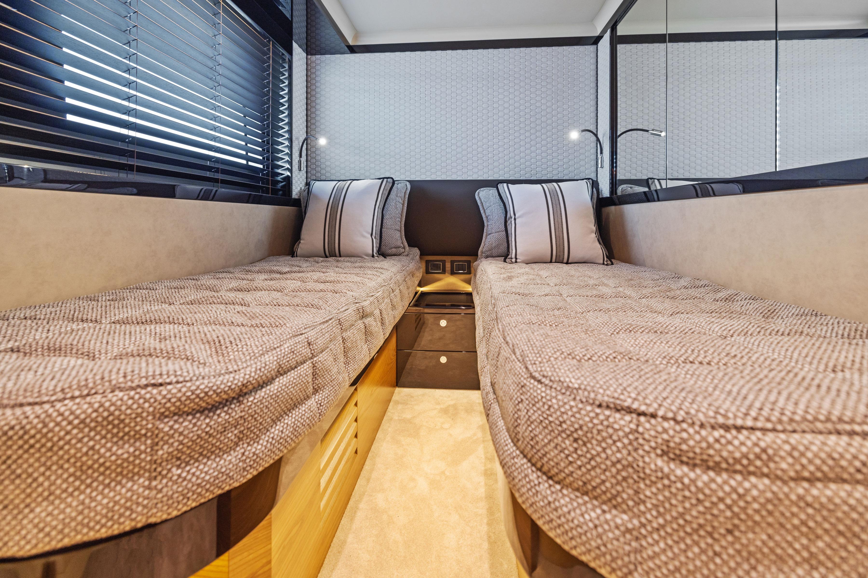2024 Absolute Navetta 64 interior cabin with twin beds and modern decor.