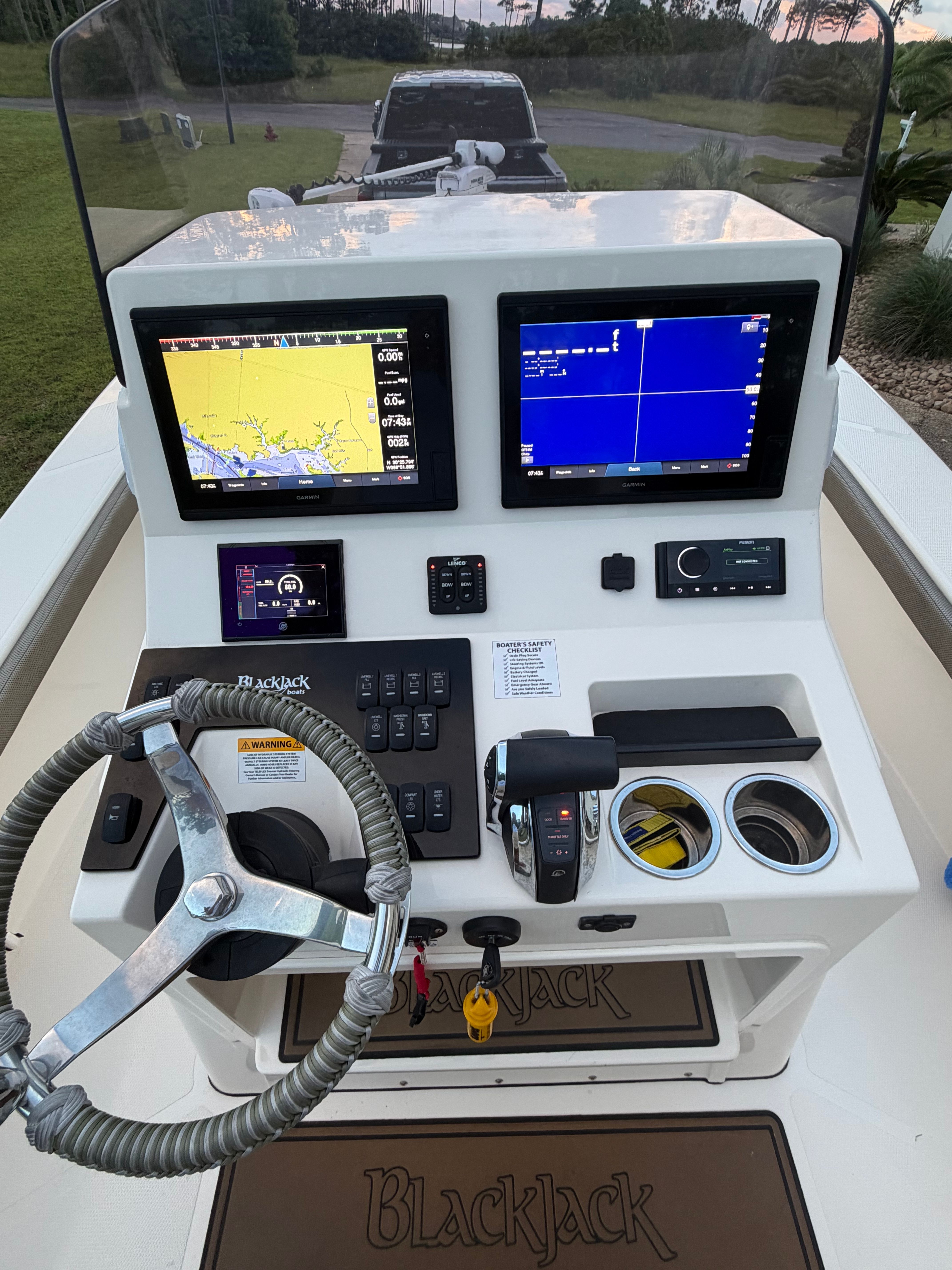 Helm console of a 2022 BlackJack 256 Coastal boat with navigation systems.