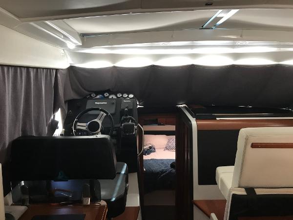 Interior of 2017 Jeanneau NC 11 boat with helm station and seating area.