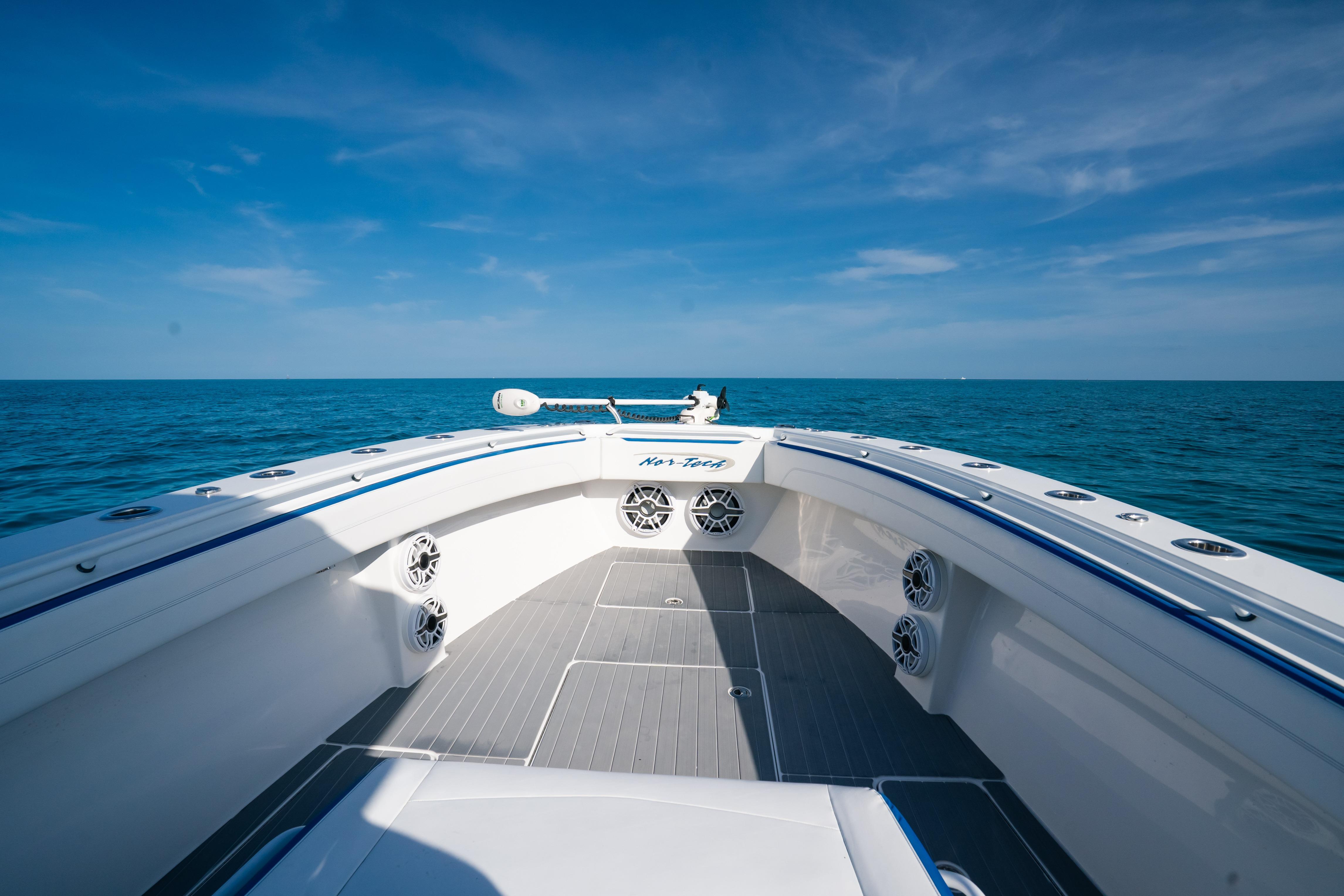 2022 Nor-Tech 392 Super Fish boat on open sea under clear blue sky.