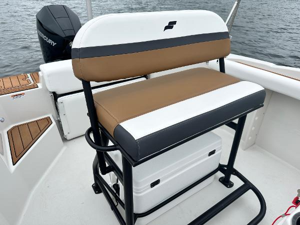 2025 Starcraft SVX 211 OB CC boat interior with cushioned seating and Mercury outboard motor.