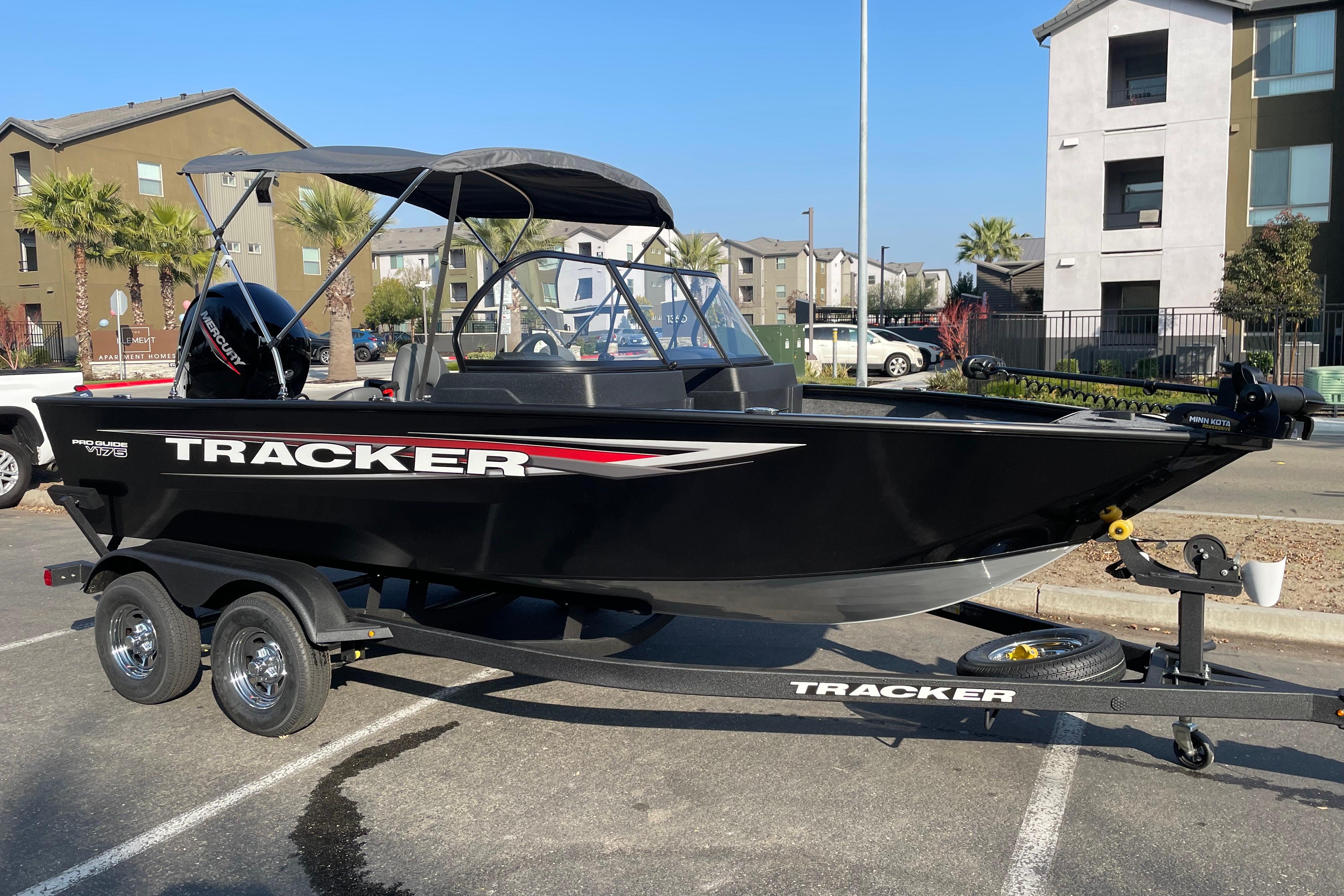 2026 Tracker Pro Guide V-175 WT boat on trailer in urban setting.