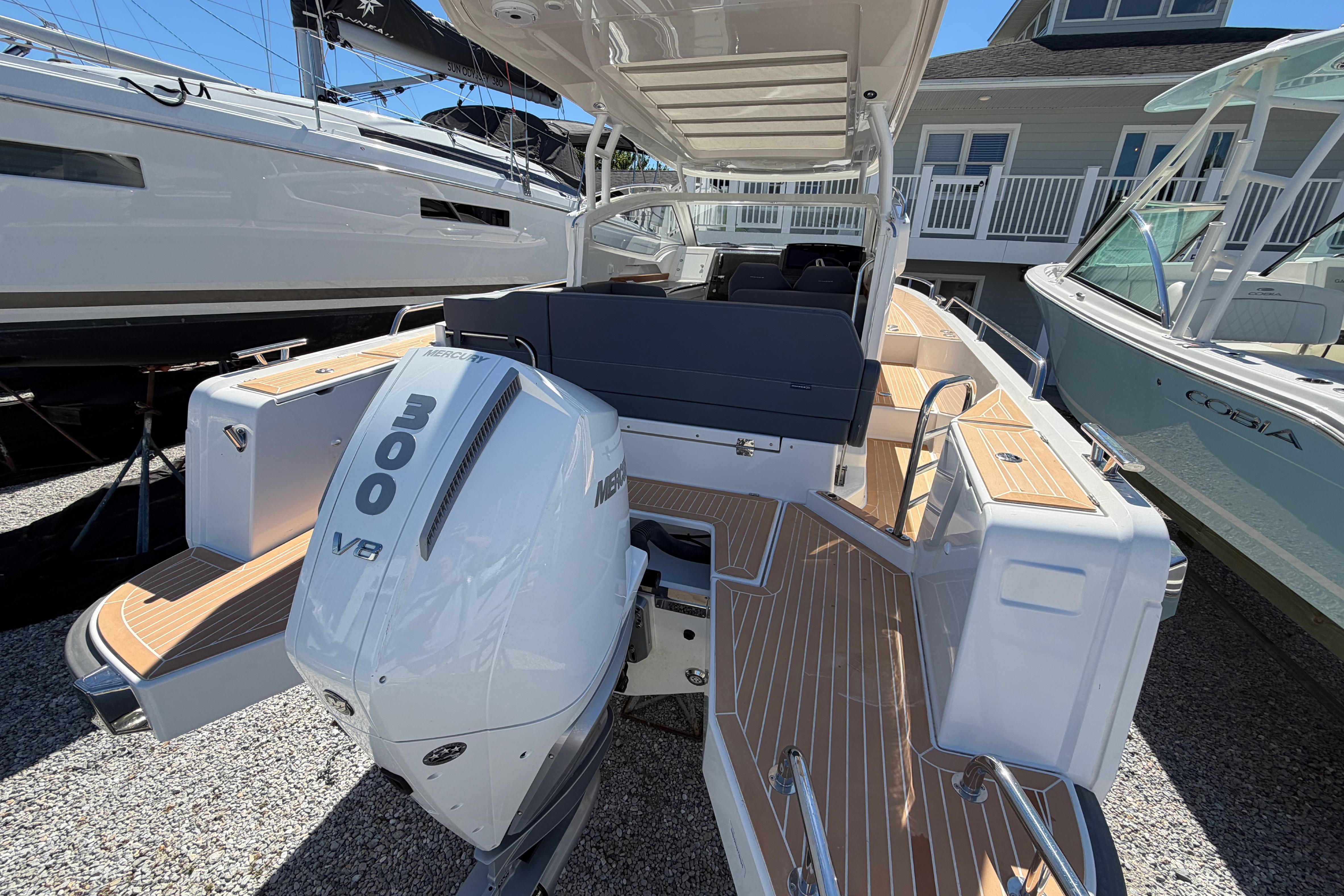 2025 Nimbus Weekender 9 boat with Mercury 300 V8 engine, docked outdoors.