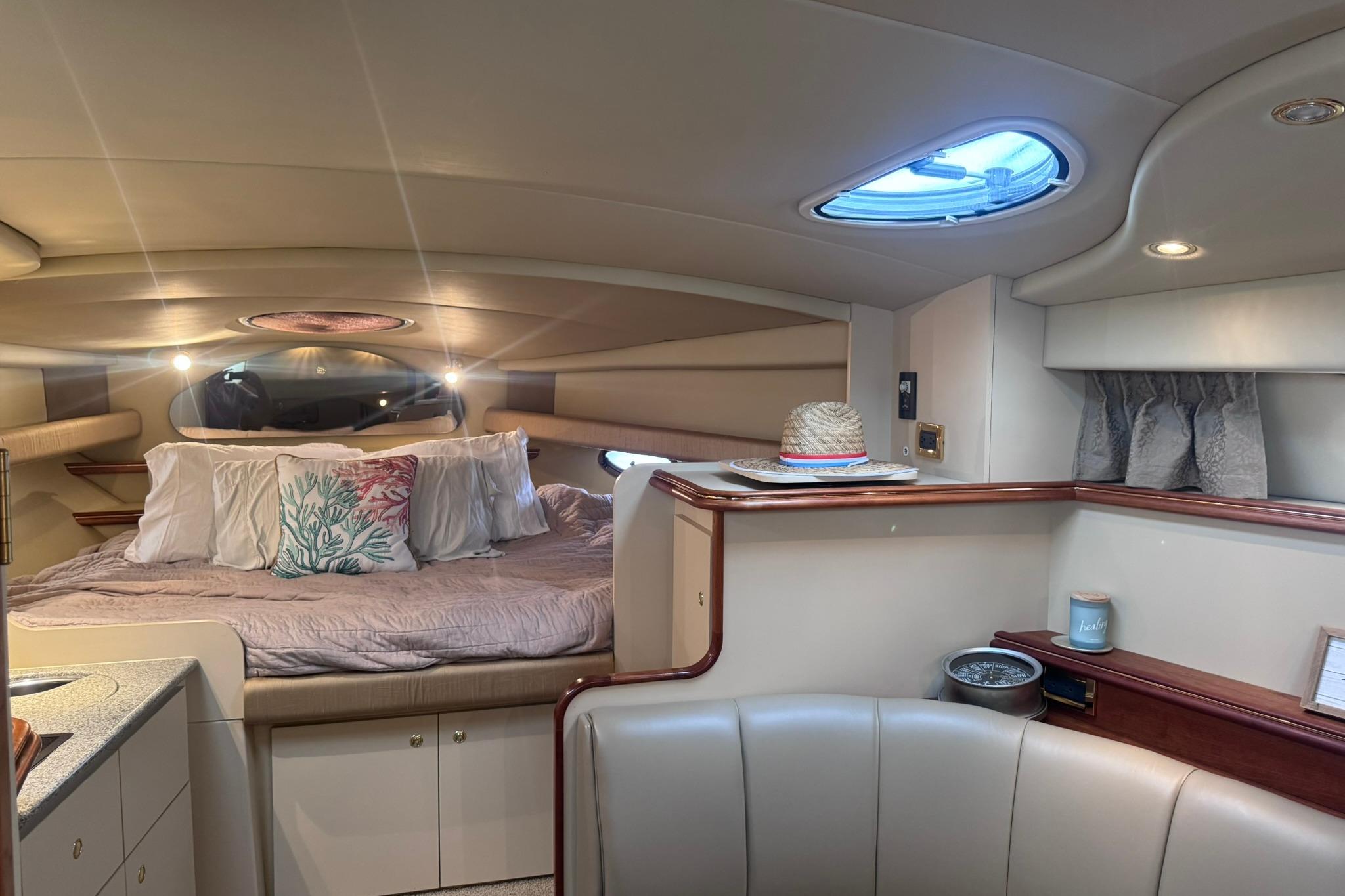 Luxurious interior of 2002 Cruisers Yachts 3275 Express with cozy bedding and elegant decor.